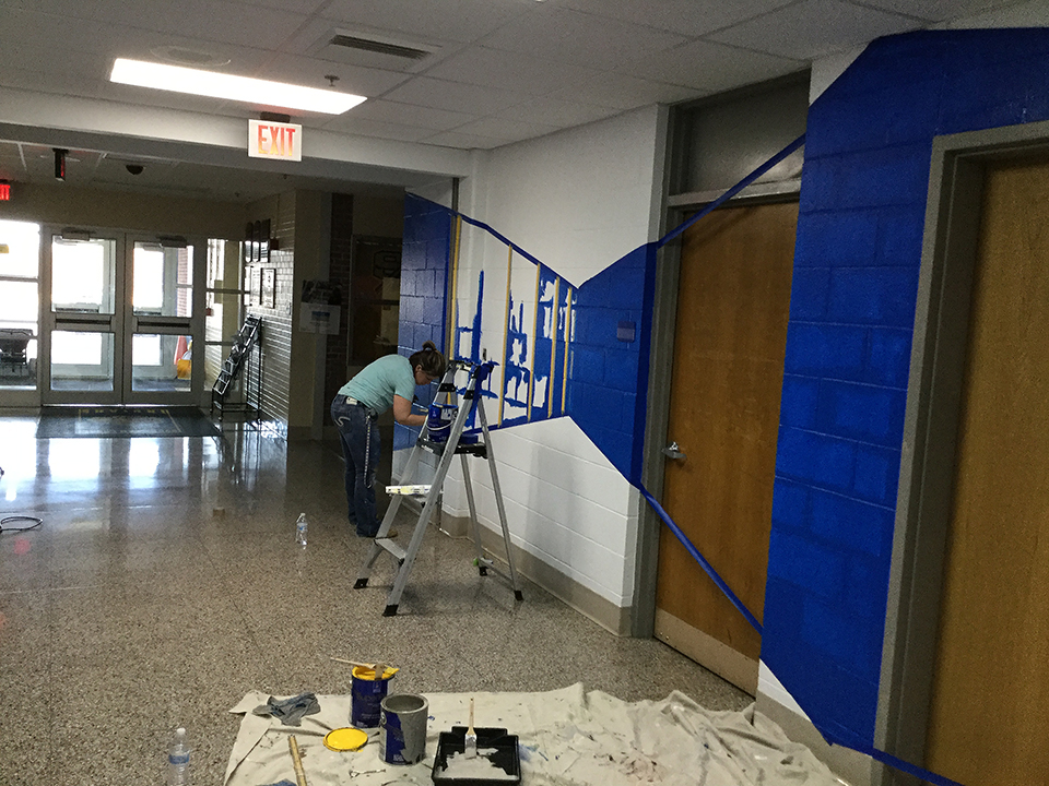 Ms. Adam painting the senior hallway