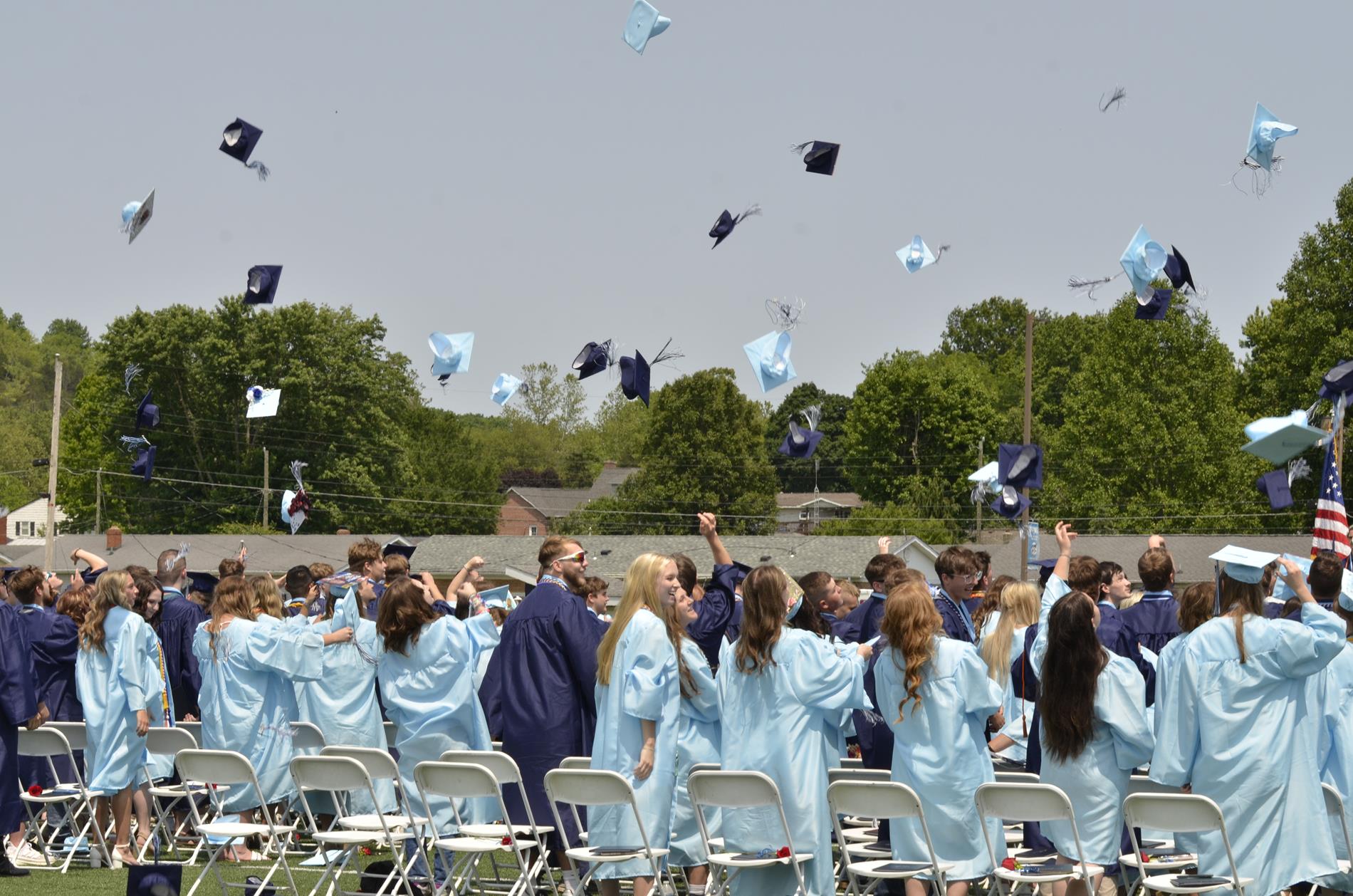 Photo credit: Steven Bath - Seniors tossing caps in the air to celebrate graduation
