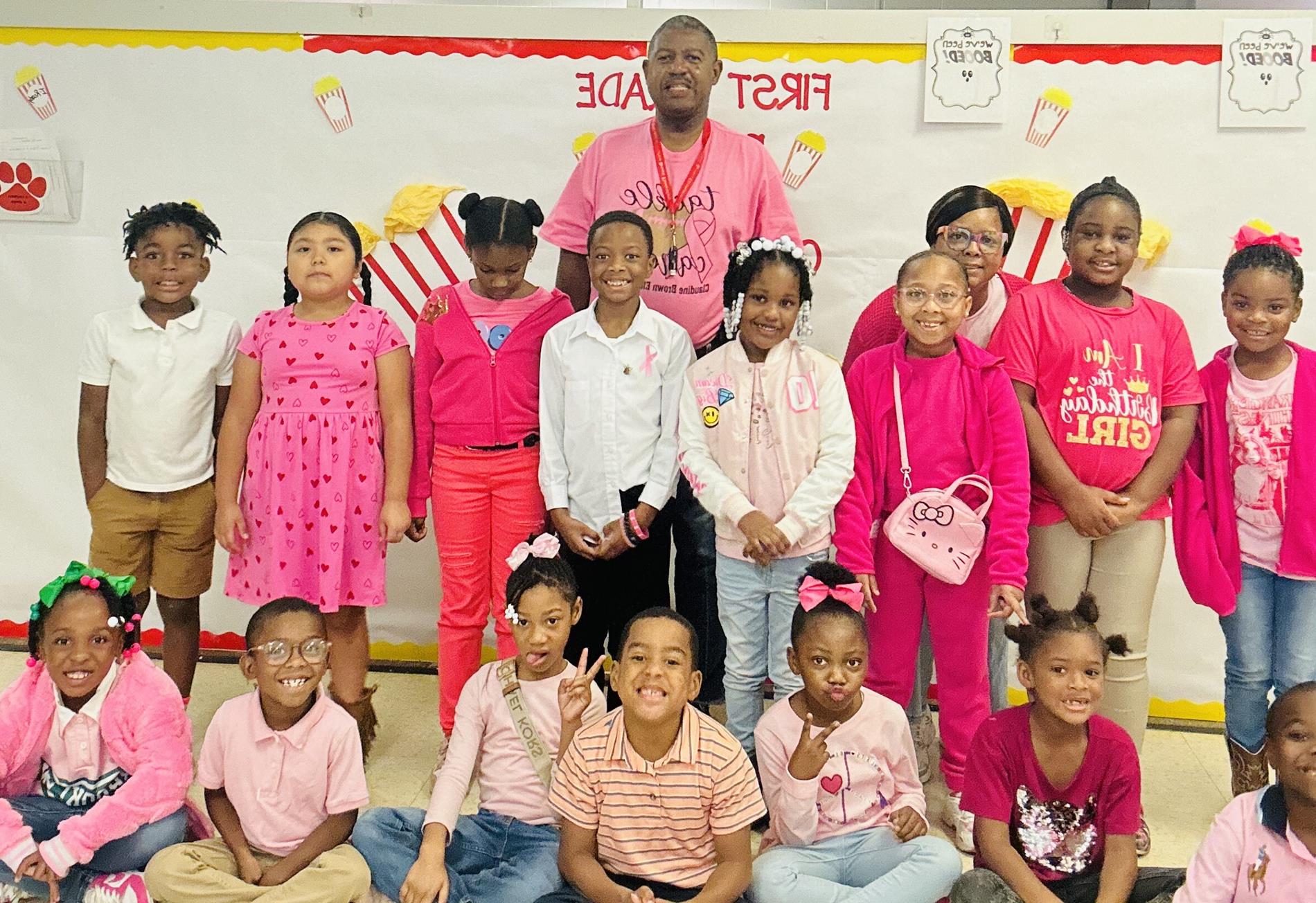First grade students posing with teachers.
