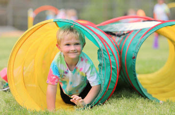 toddler in play tunnel