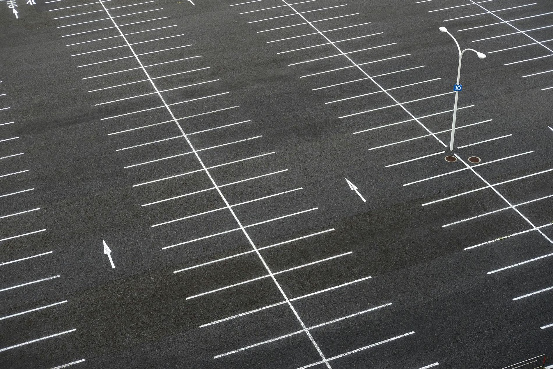 A parking lot with white lines on it from an aerial view
