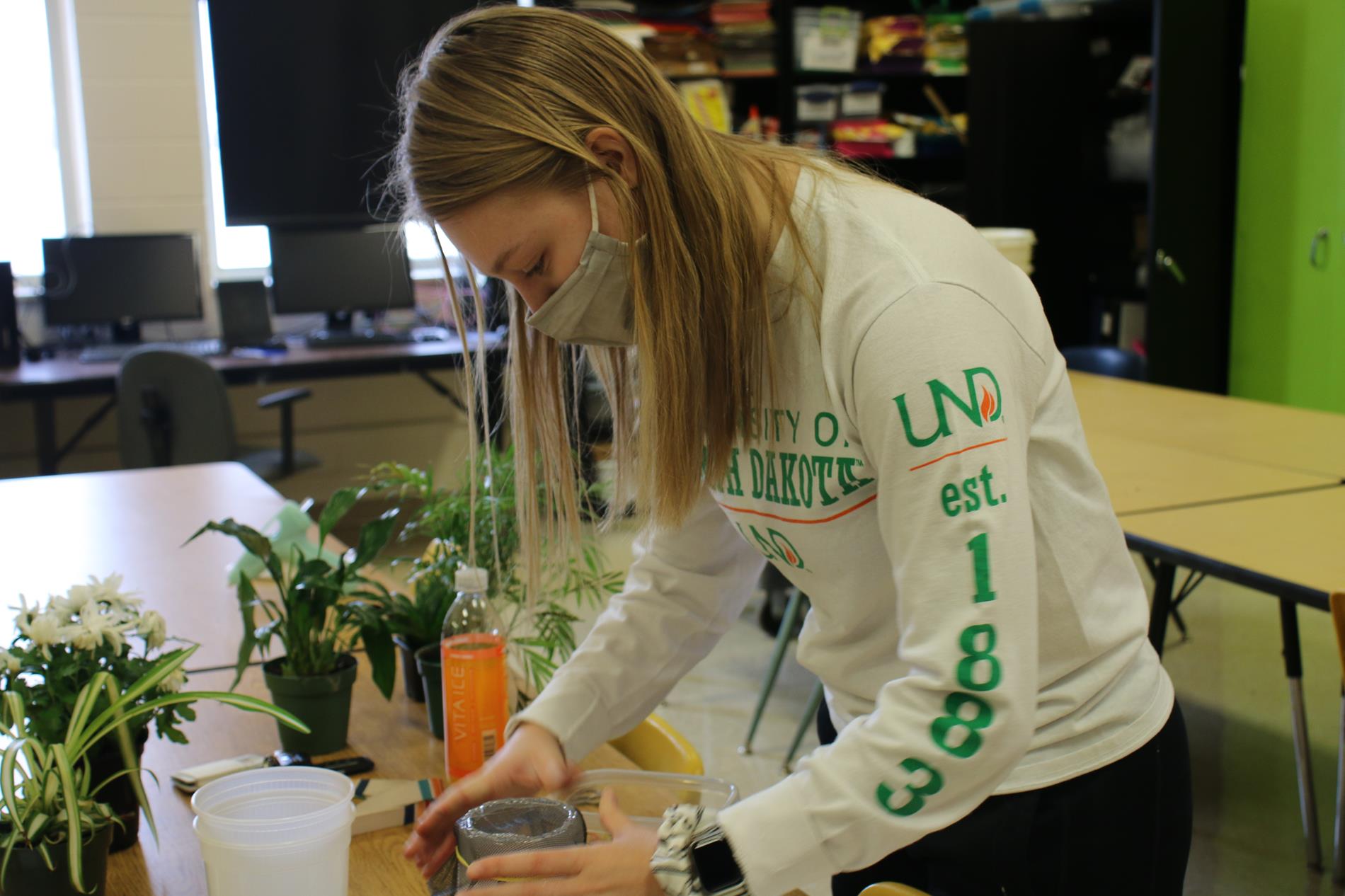 A student working with plants for her project