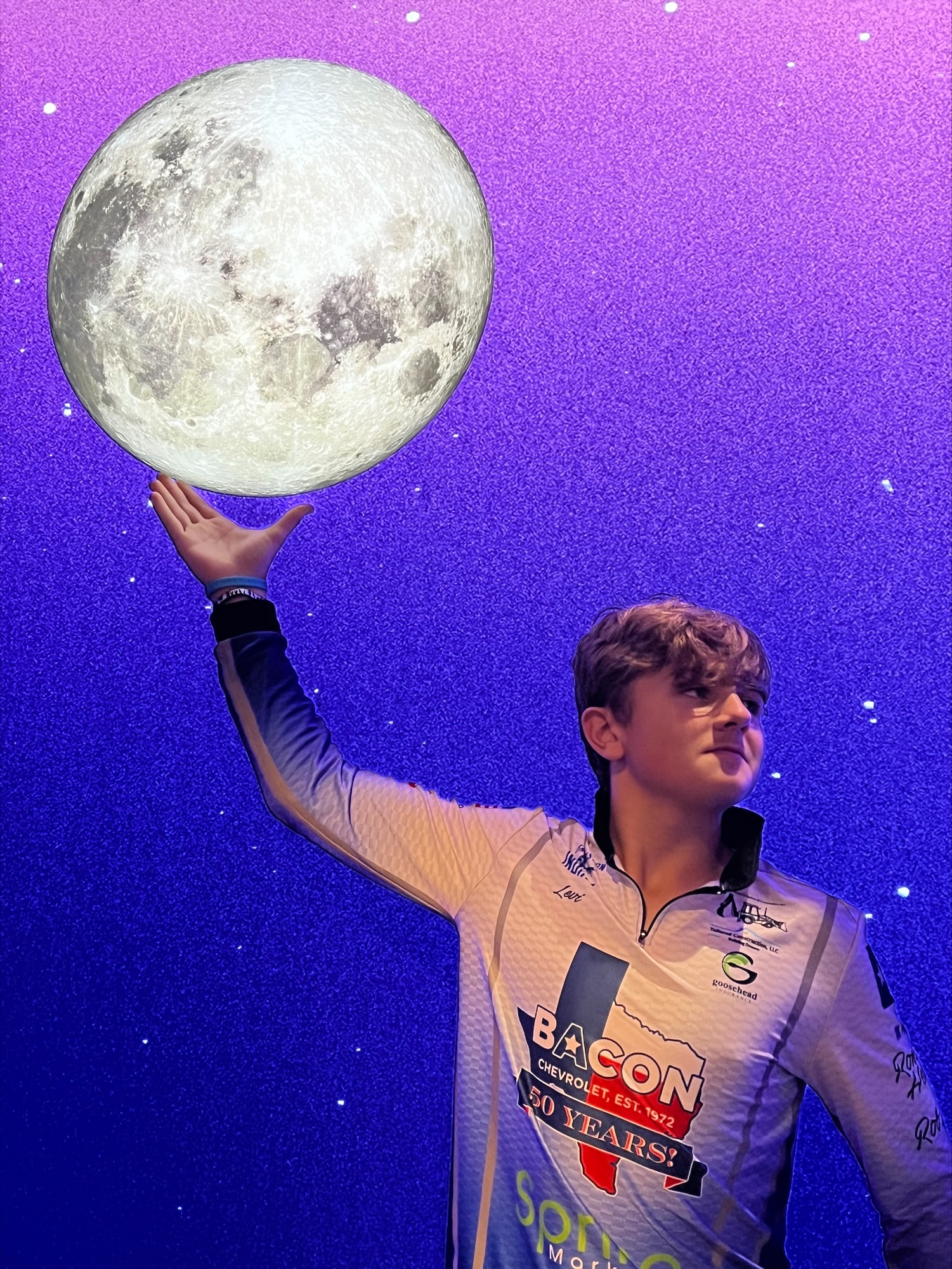 Student posed holding the moon