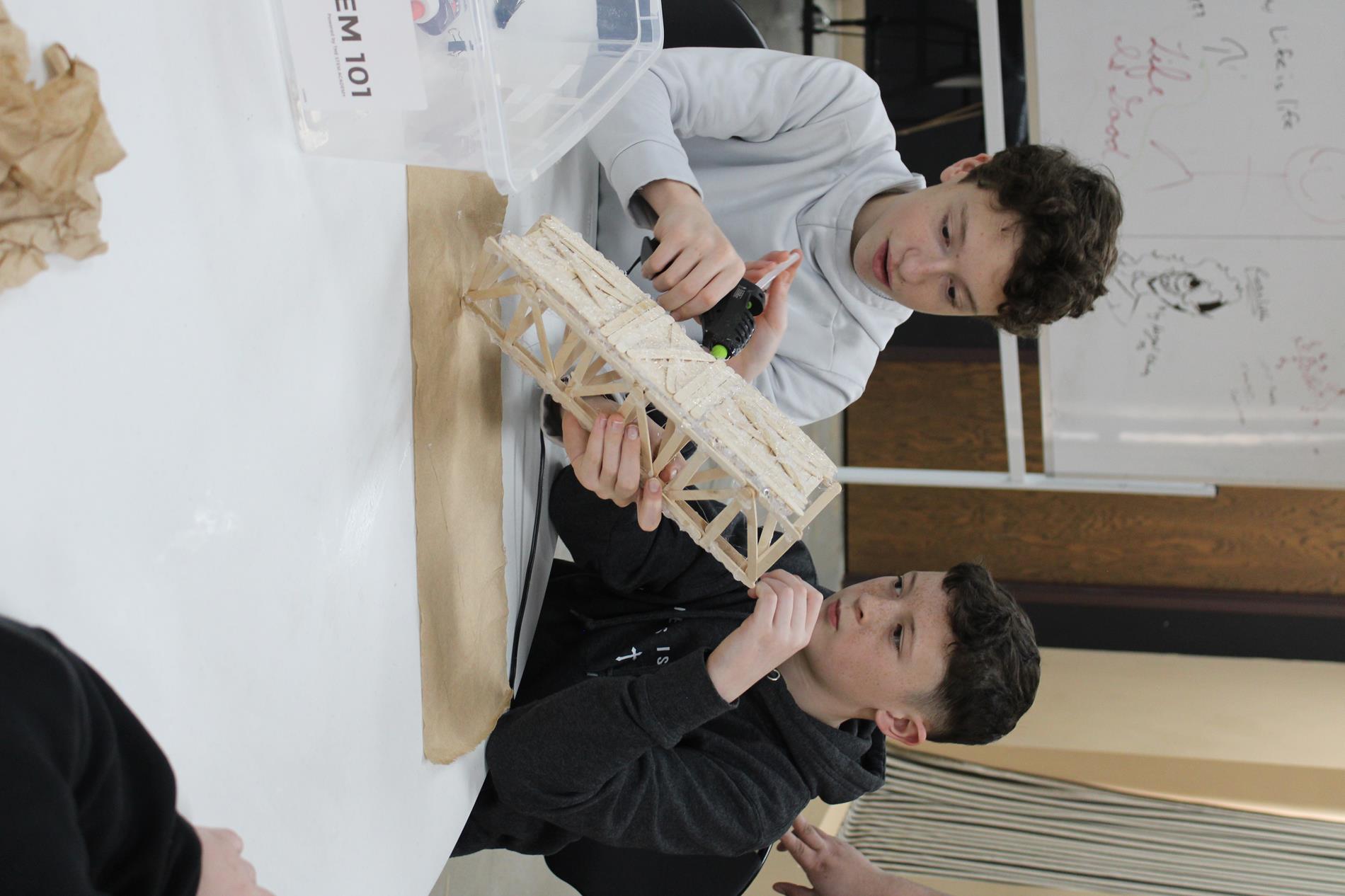 STEM Students Building Bridge with Popsicle Sticks