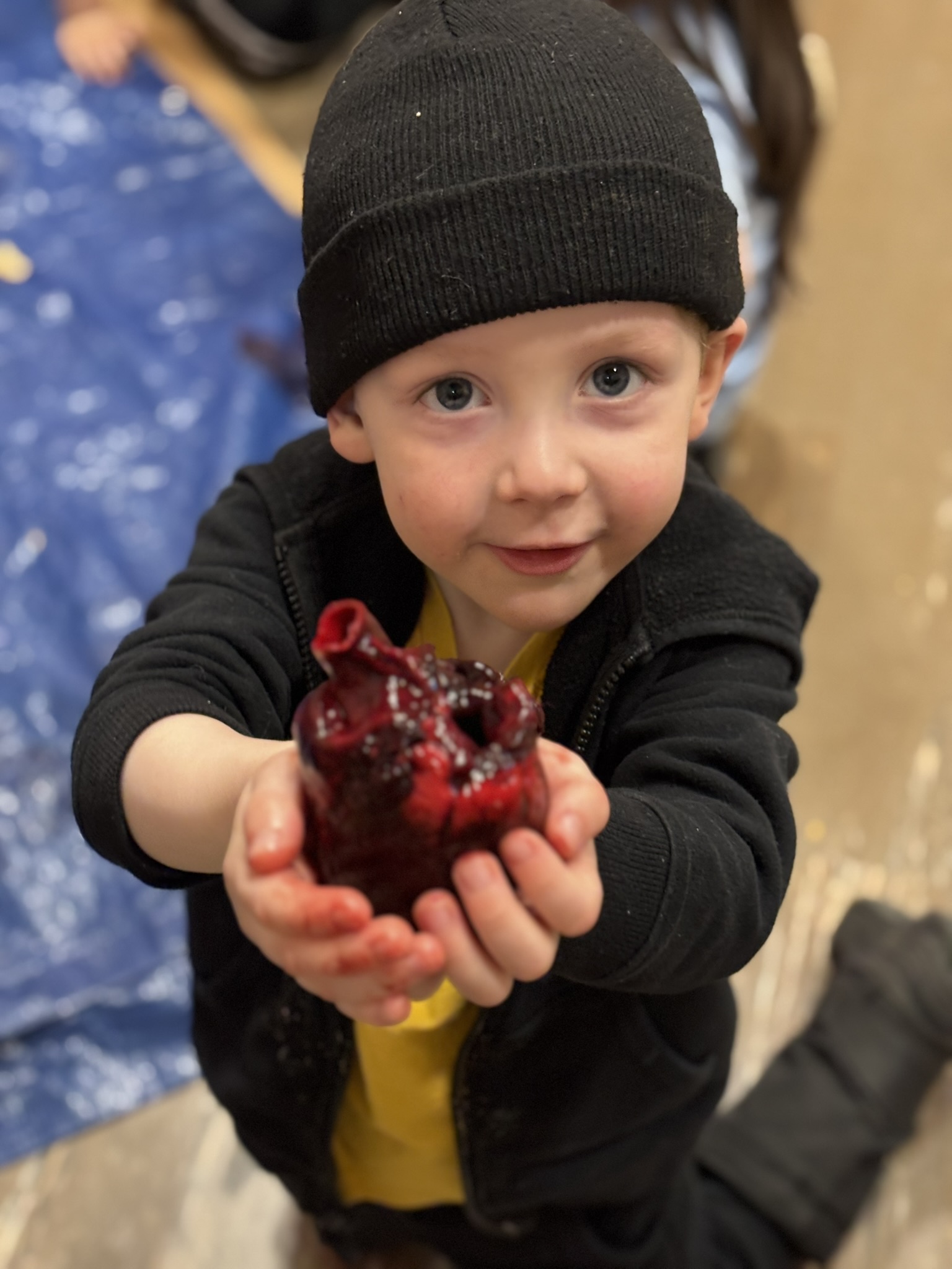 student holding heart