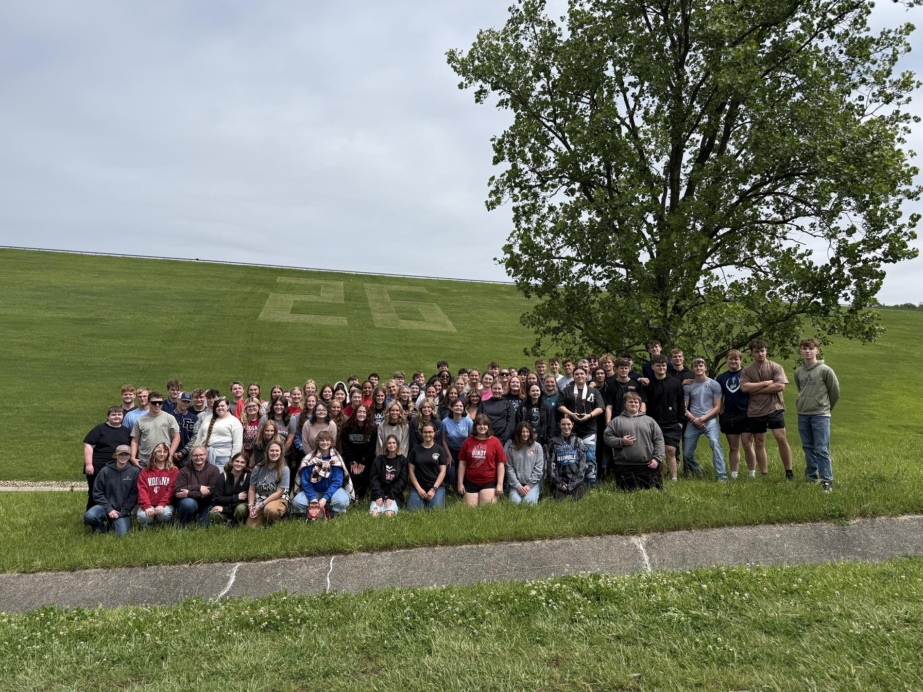 FCHS Seniors standing in front of the "26" inscribed on the face of Brookville Dam to show their hard work 