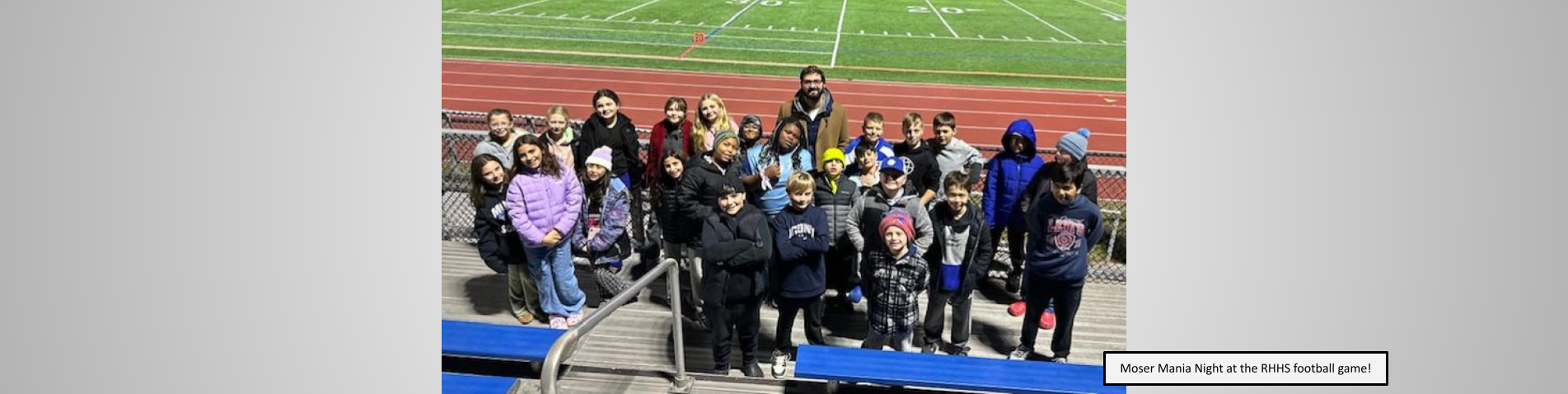 Students and Principal posing for a photo at the RHHS football game