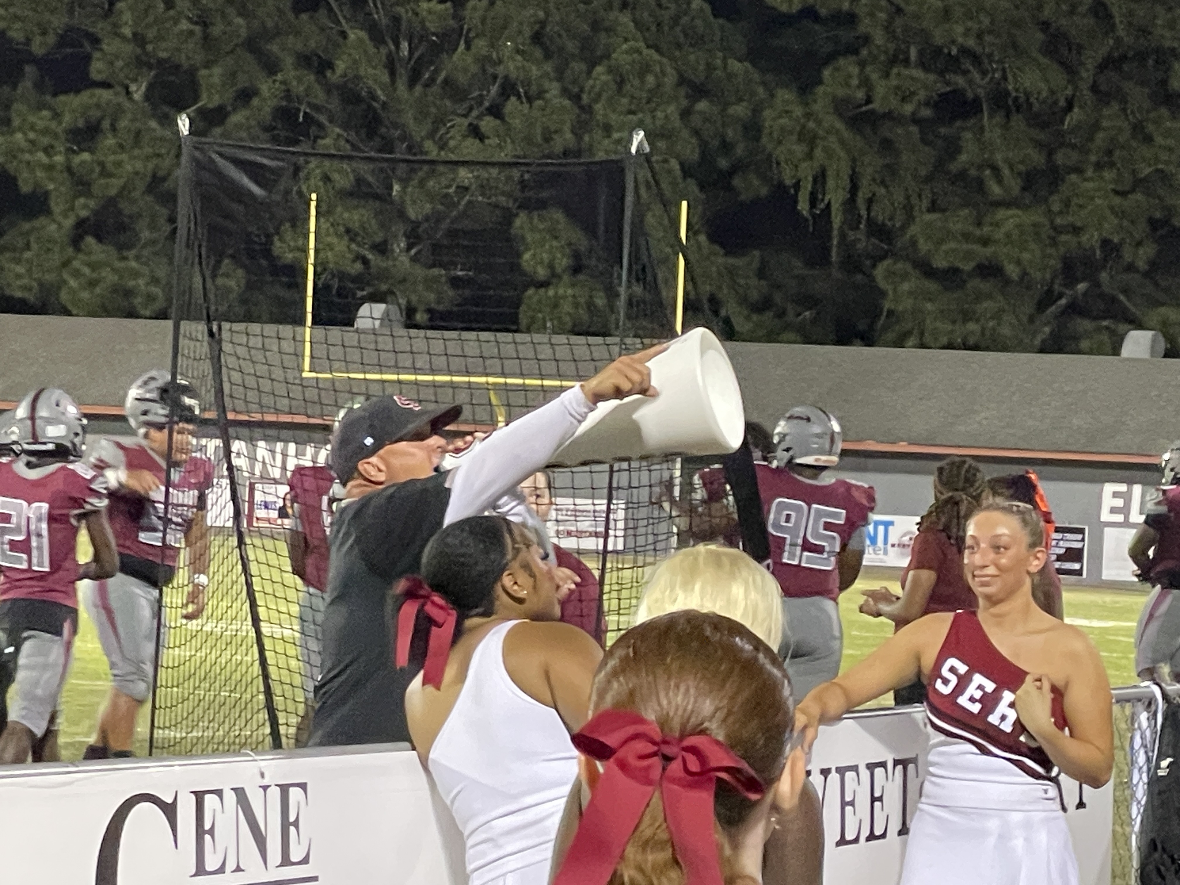 Coach Fuller Leading Students in Cheer