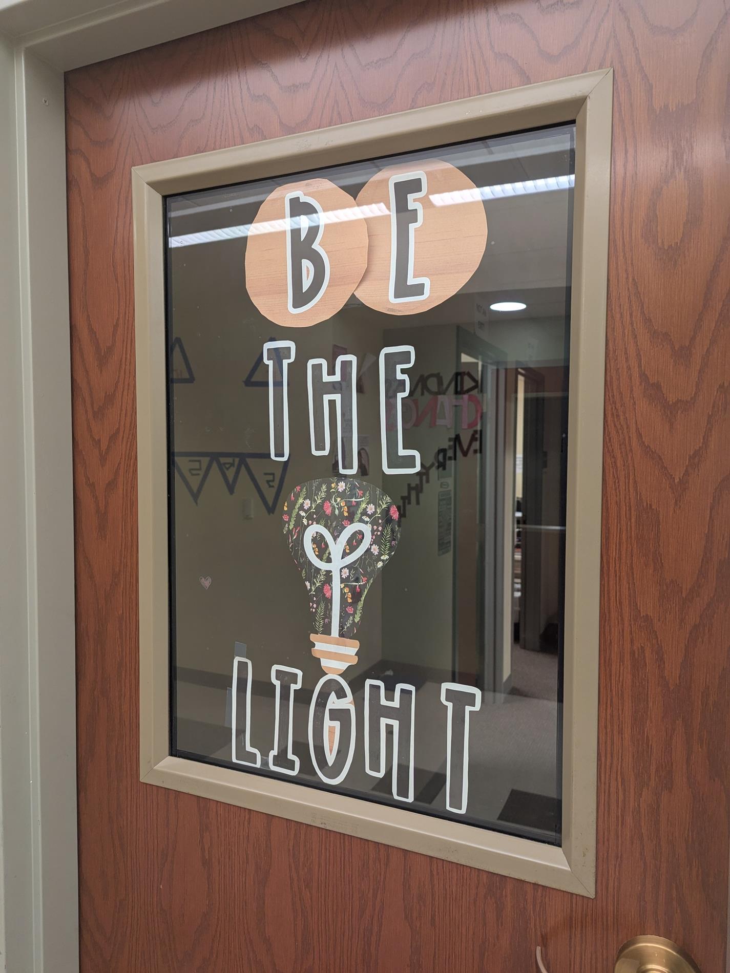 Door with decal. Decal reads "Be the light"