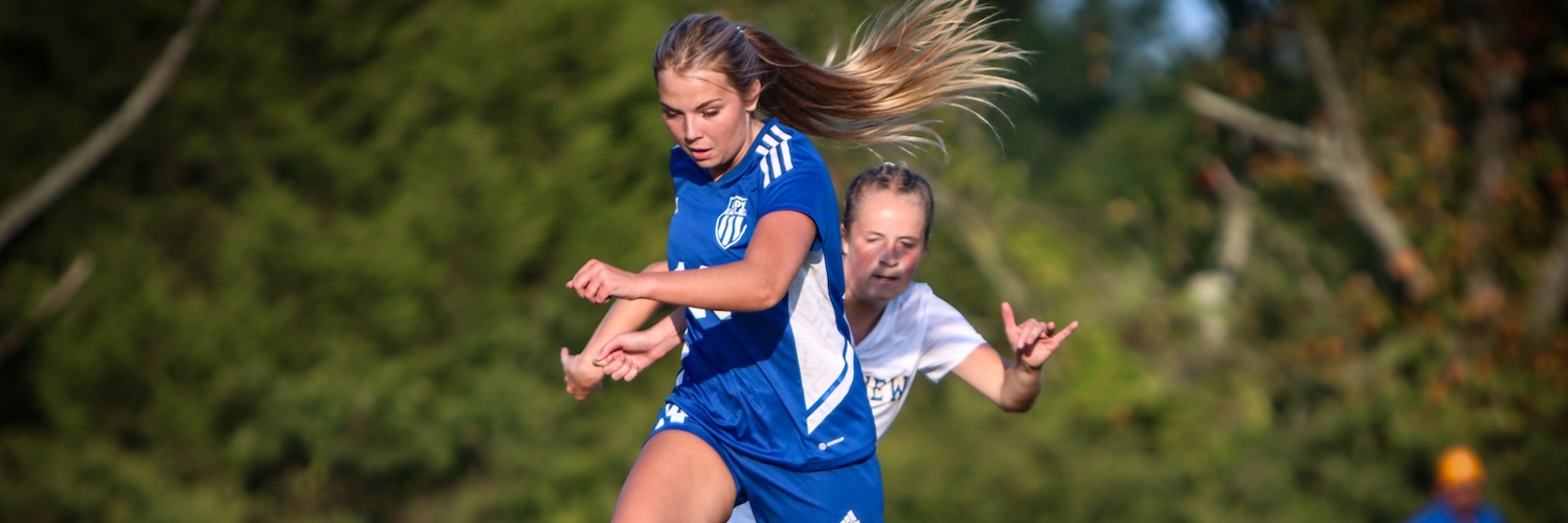 CCHS girl's soccer player dribbles the ball