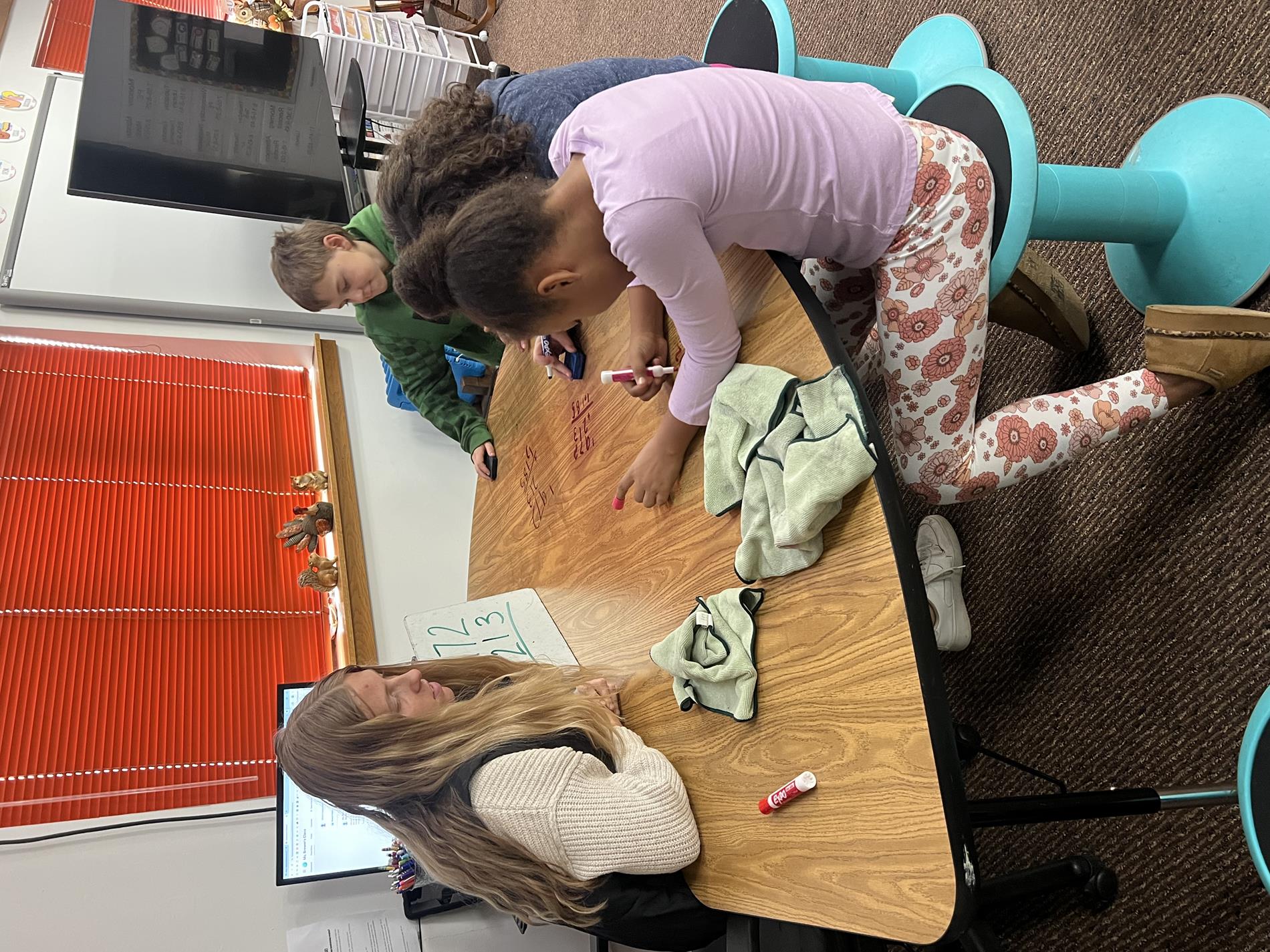 Miss Brewer working with her students during Friday School