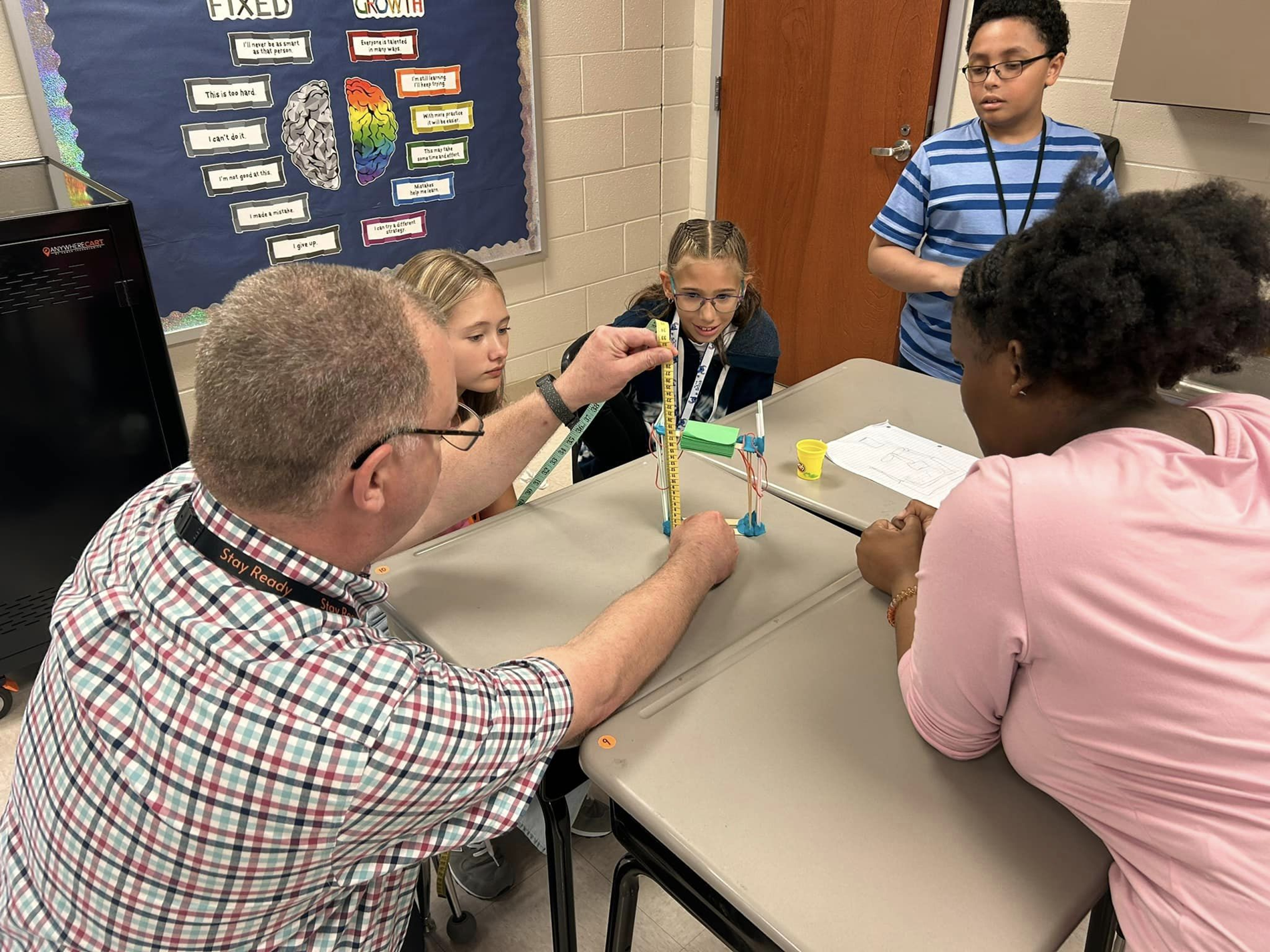 Teacher and students working together in classroom