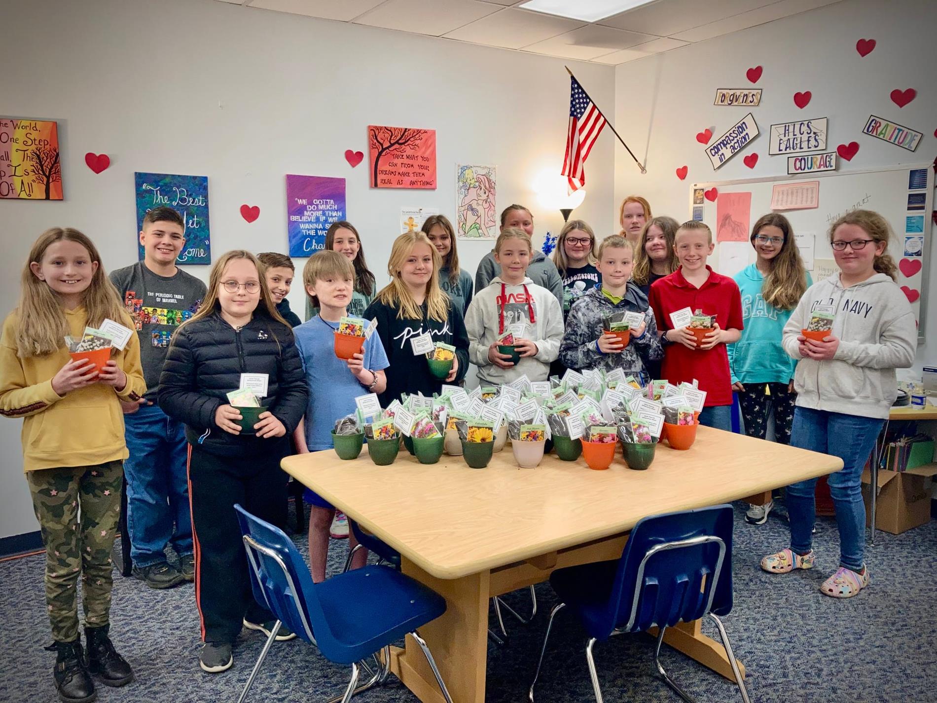students hold flowers for teacher gifts