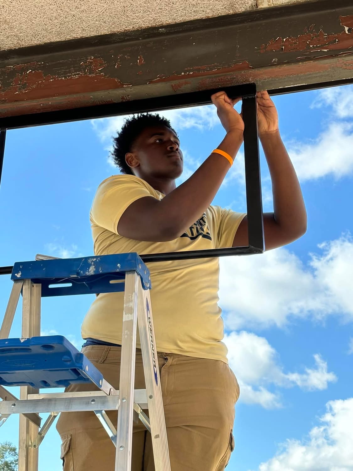 Welding student working on pull up bar