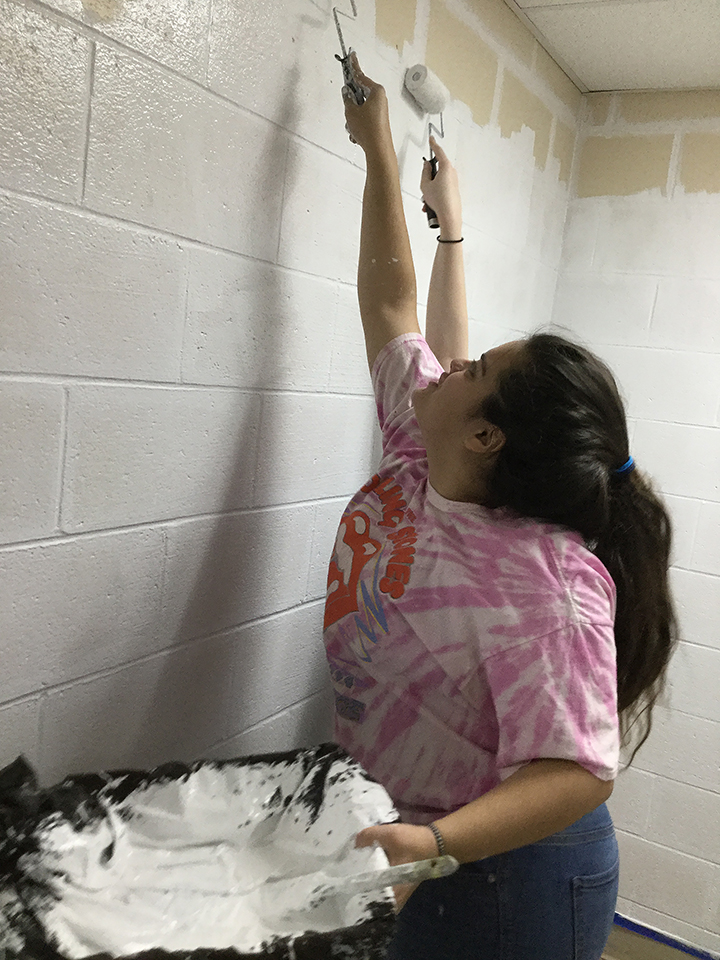 Students volunteering to help paint