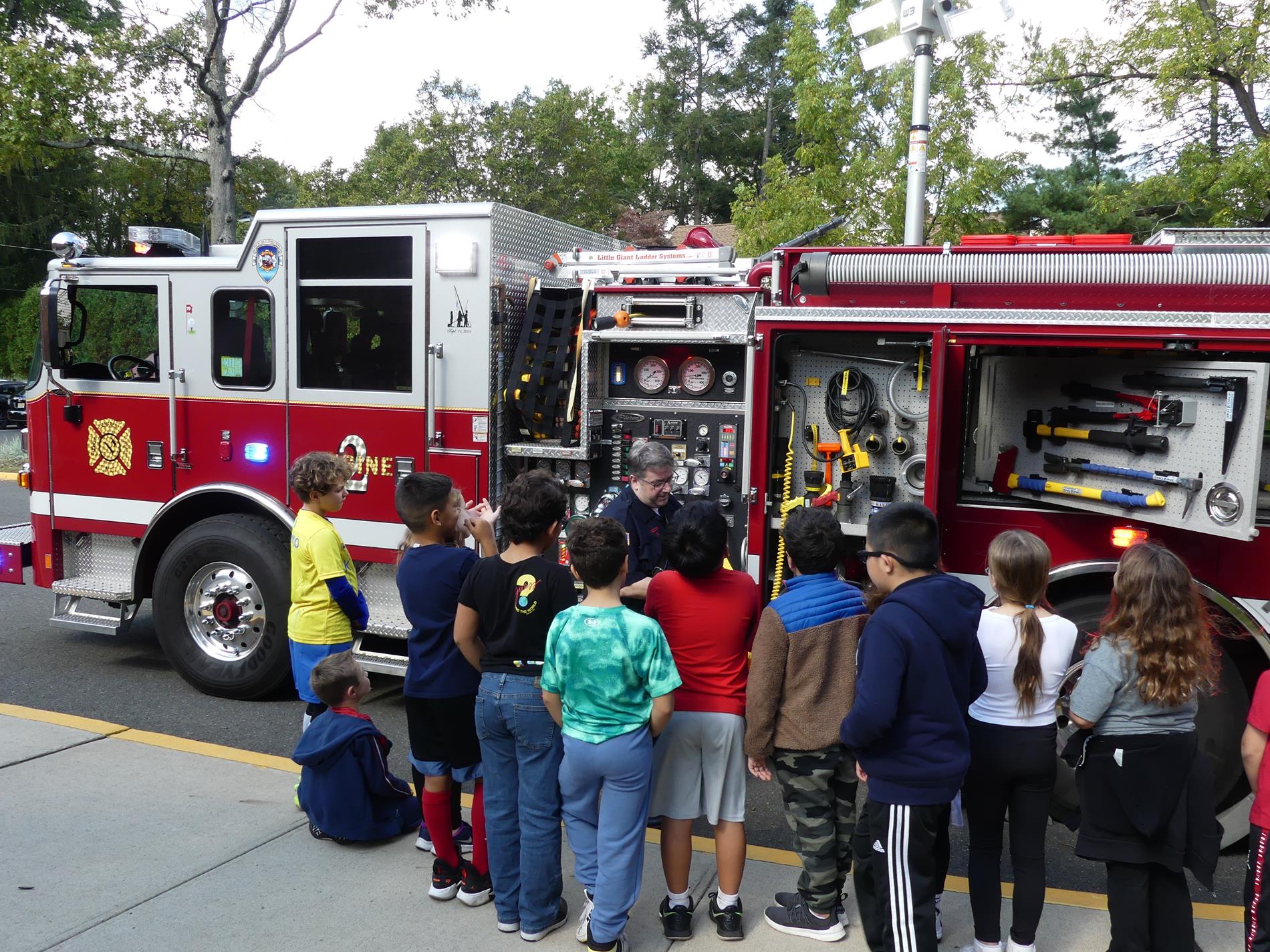 Students learning about fire truck and equipment