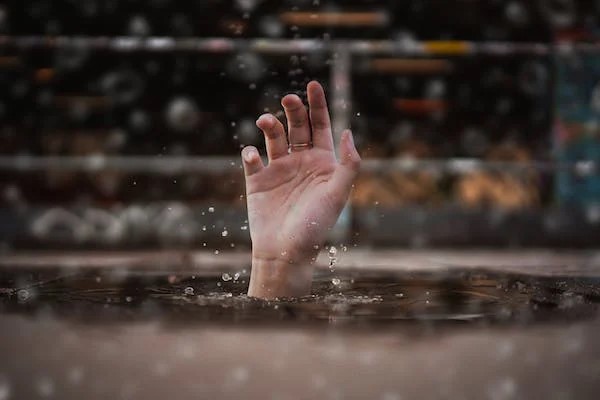 Hand above water