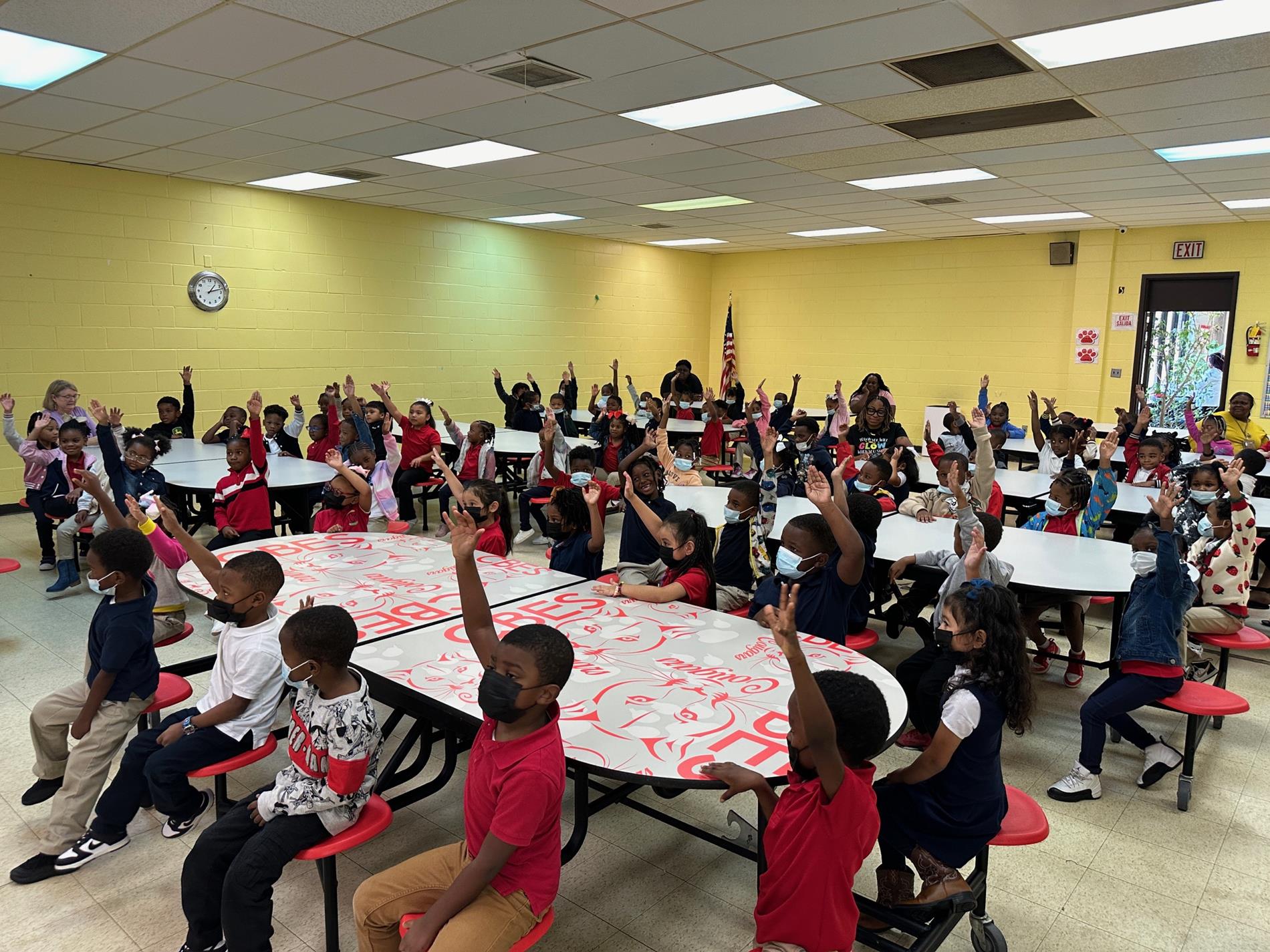 Students volunteering by a show of hands to participate.