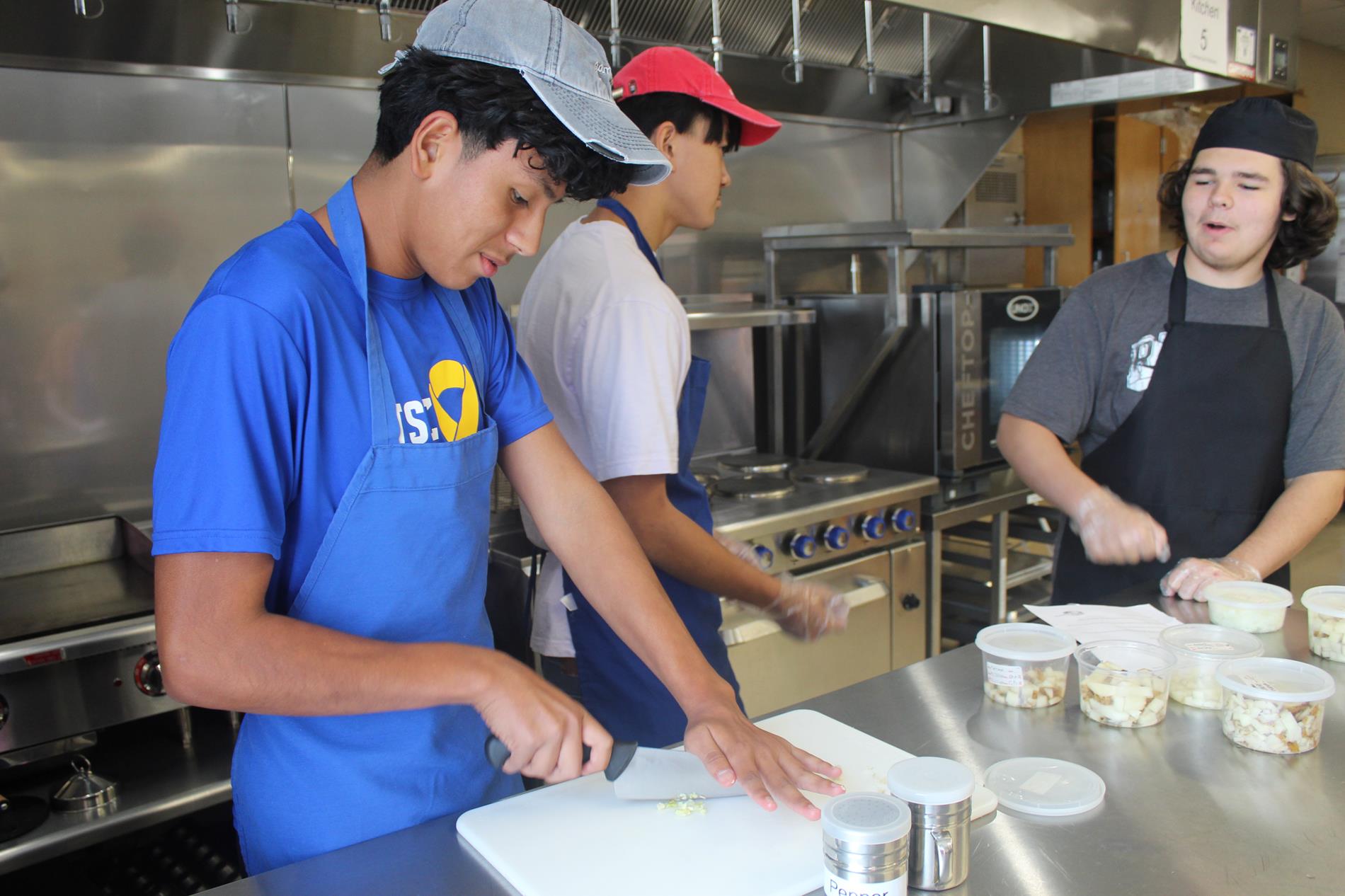 three students preparing food in Culinary Arts