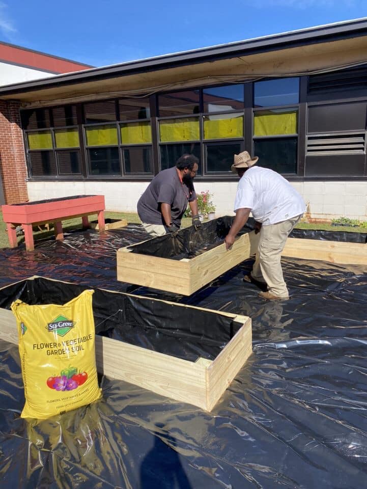 Workers Adjusting the Flower Beds