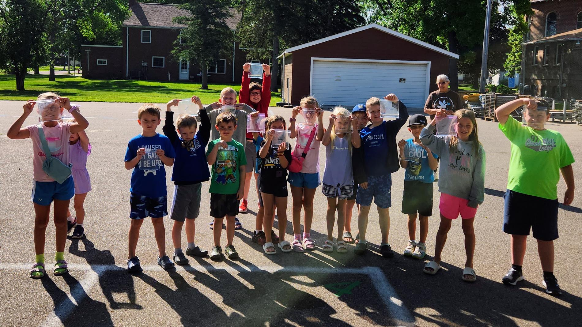 Children Smiling holding bags of ice