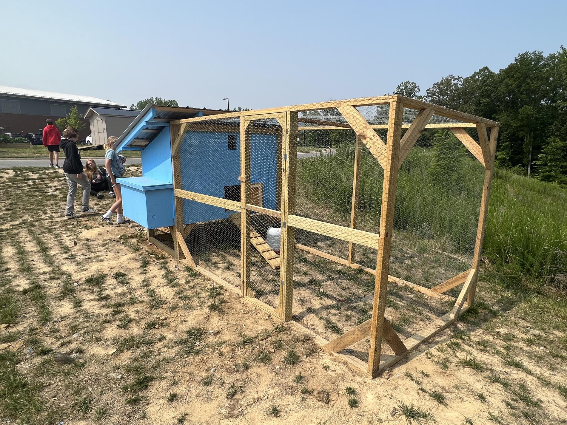 photo of blue chicken coop outside the school
