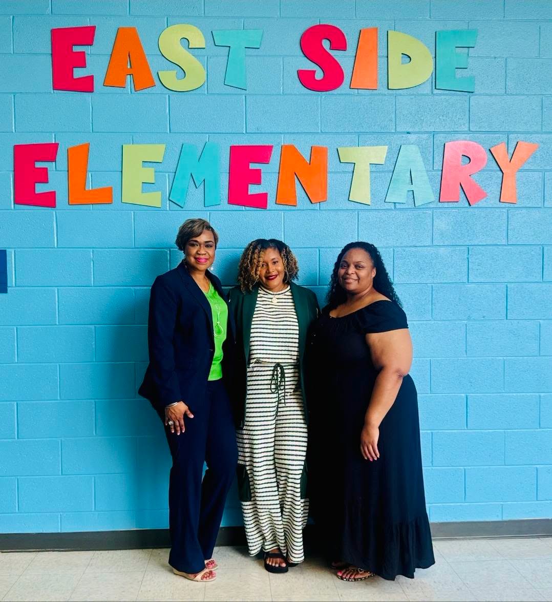 East Side Elementary representatives and community partners pose together during a back-to-school breakfast for teachers and staff.