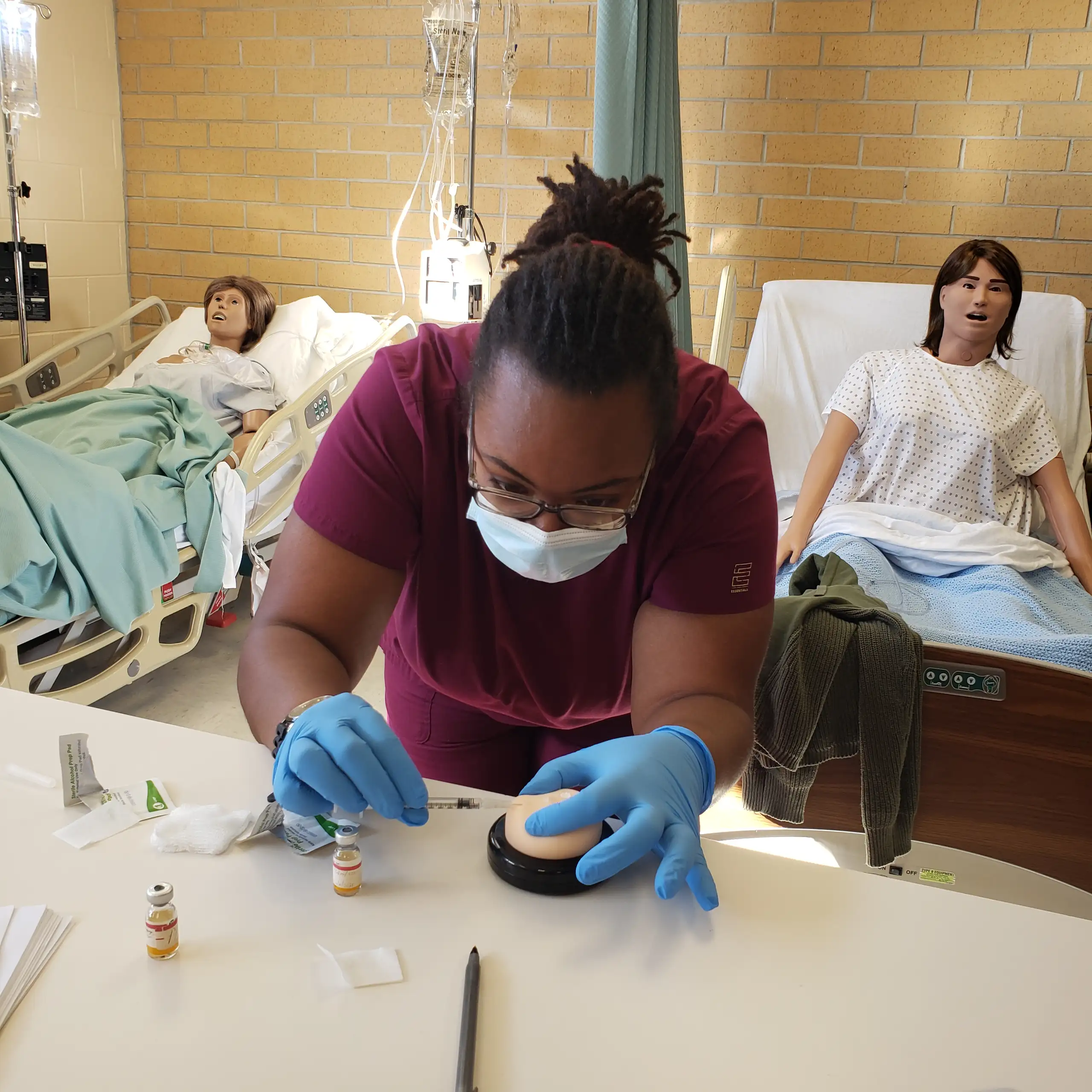 Nursing student performing a procedure in class.