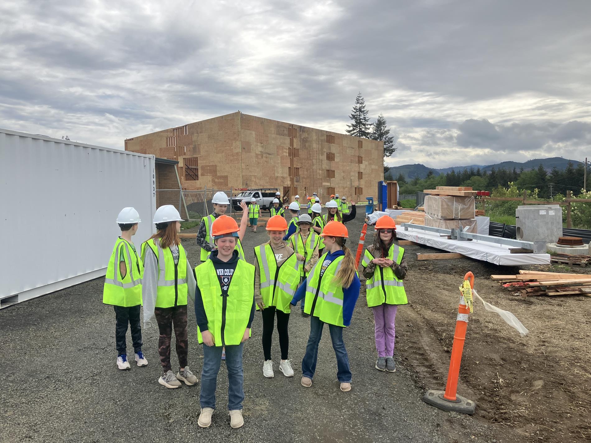 A group of students visiting the construction site safely. 