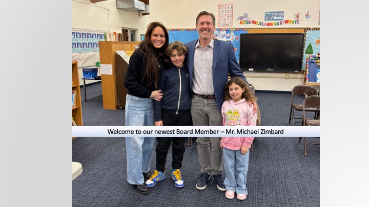 Board member and family standing in a library