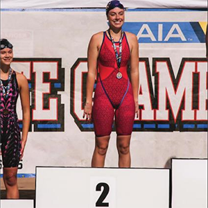 Knights junior Olivia Badaracco standing on the 2nd place podium at the state championships