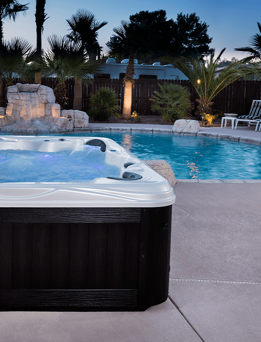 hot tub next to pool in evening