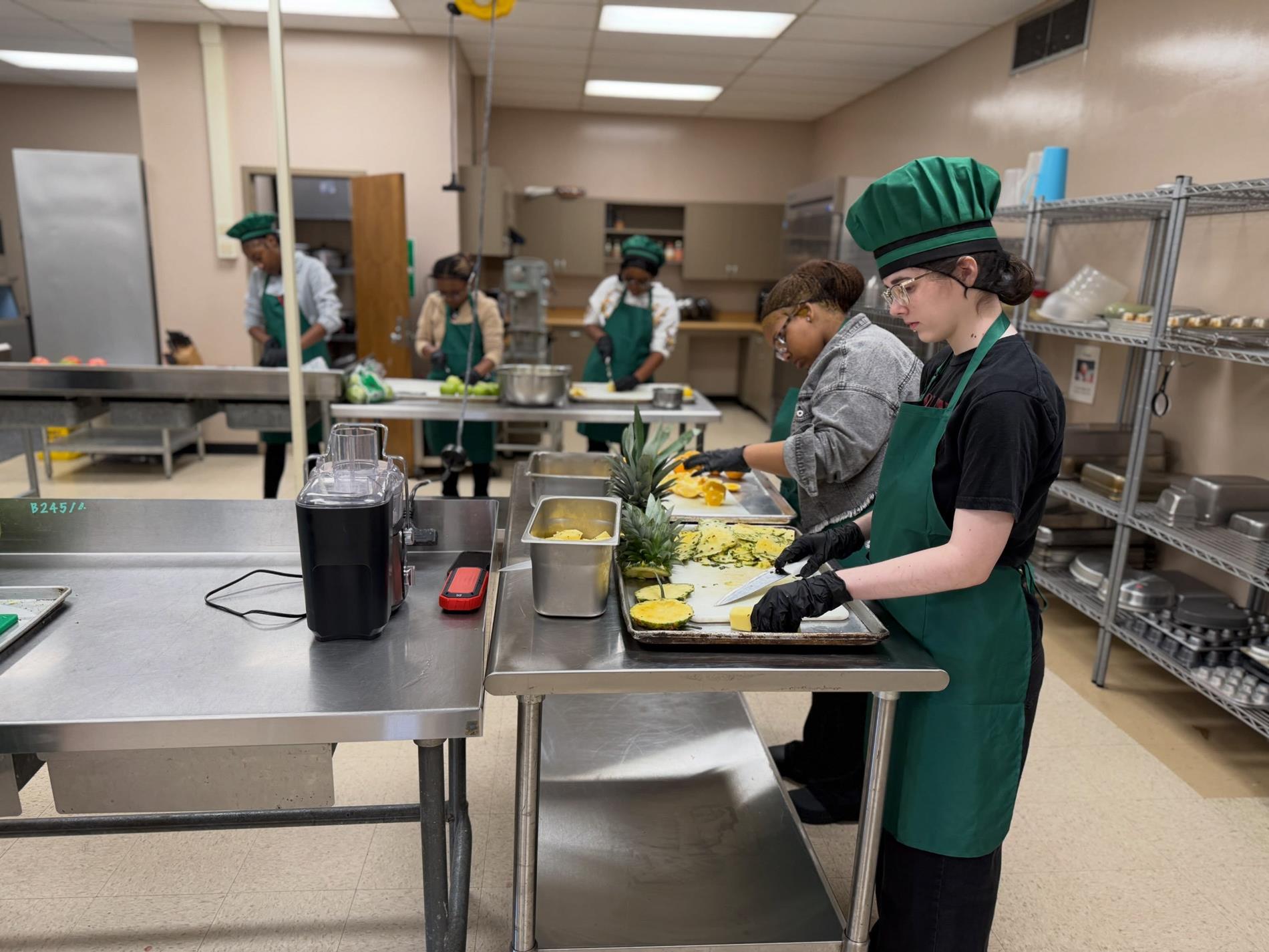WPCTC Culinary Arts 2 students preparing food and practicing kitchen skills under the direction of Chef Neely.