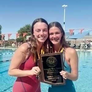 Girls Swim Team holding Championship plaque