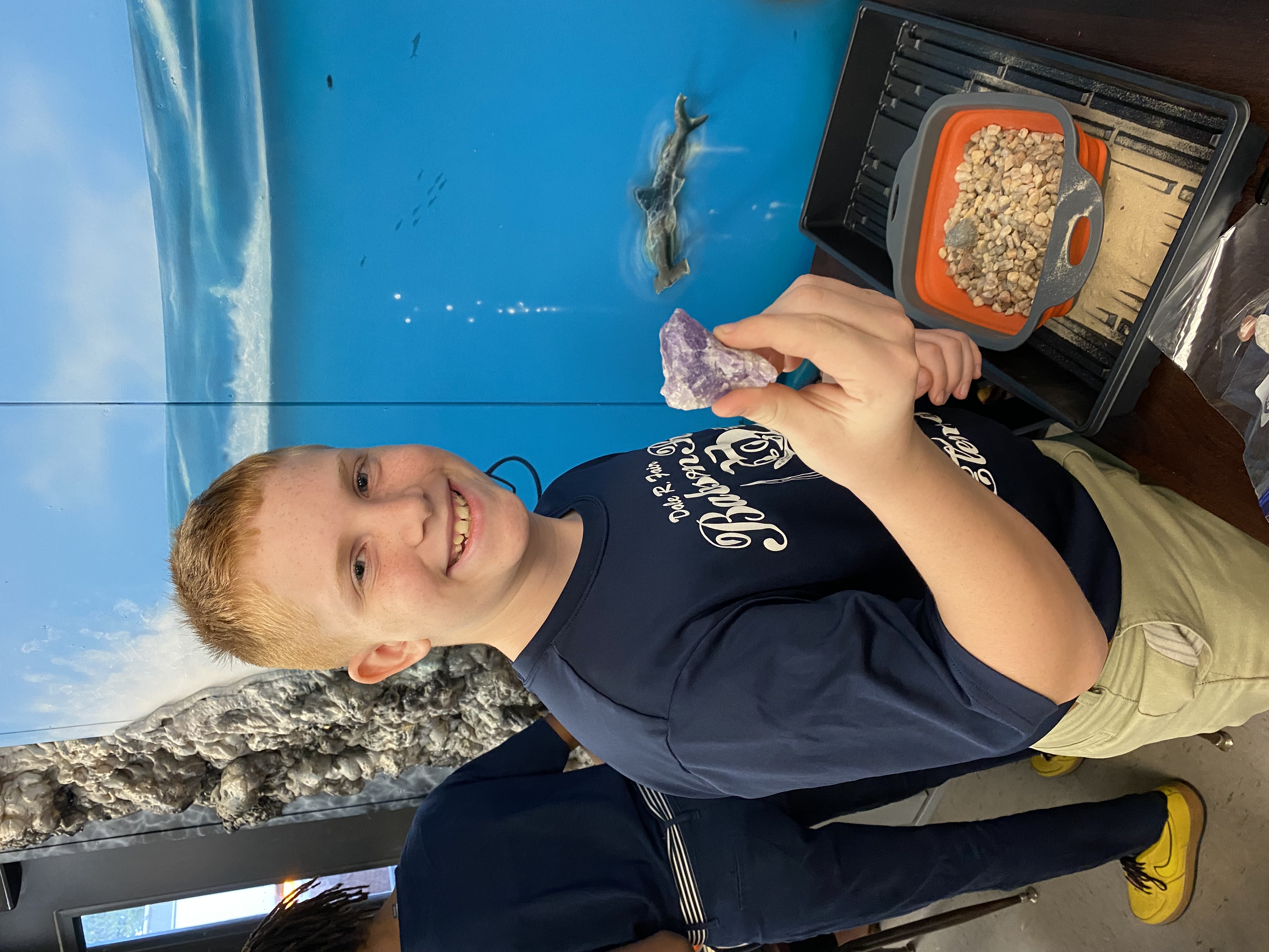 One of students excited to show off their findings from their mining for rocks and minerals.