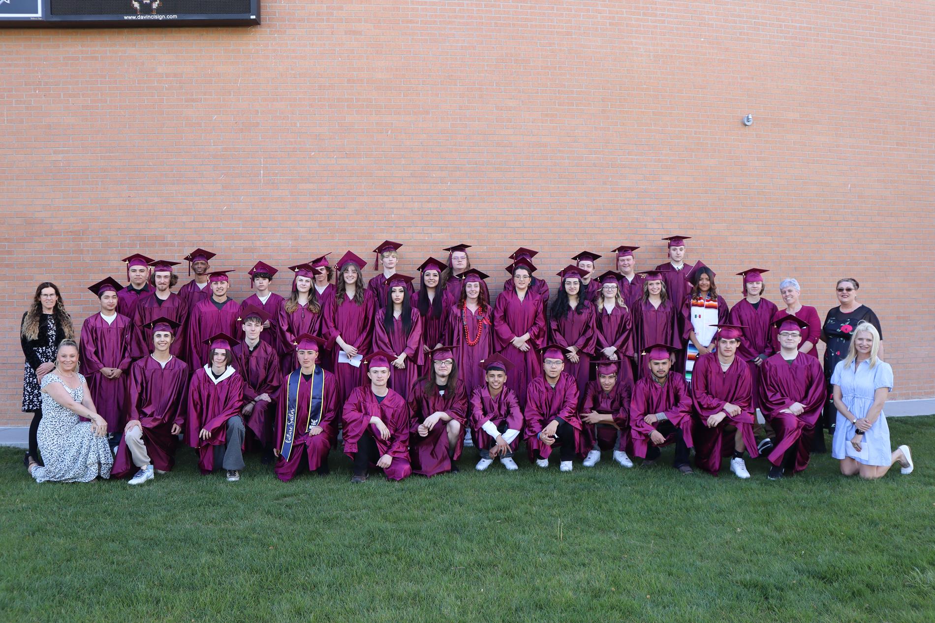 CBOCES High School Greeley Graduates in a group picture with their teachers standing next to them.