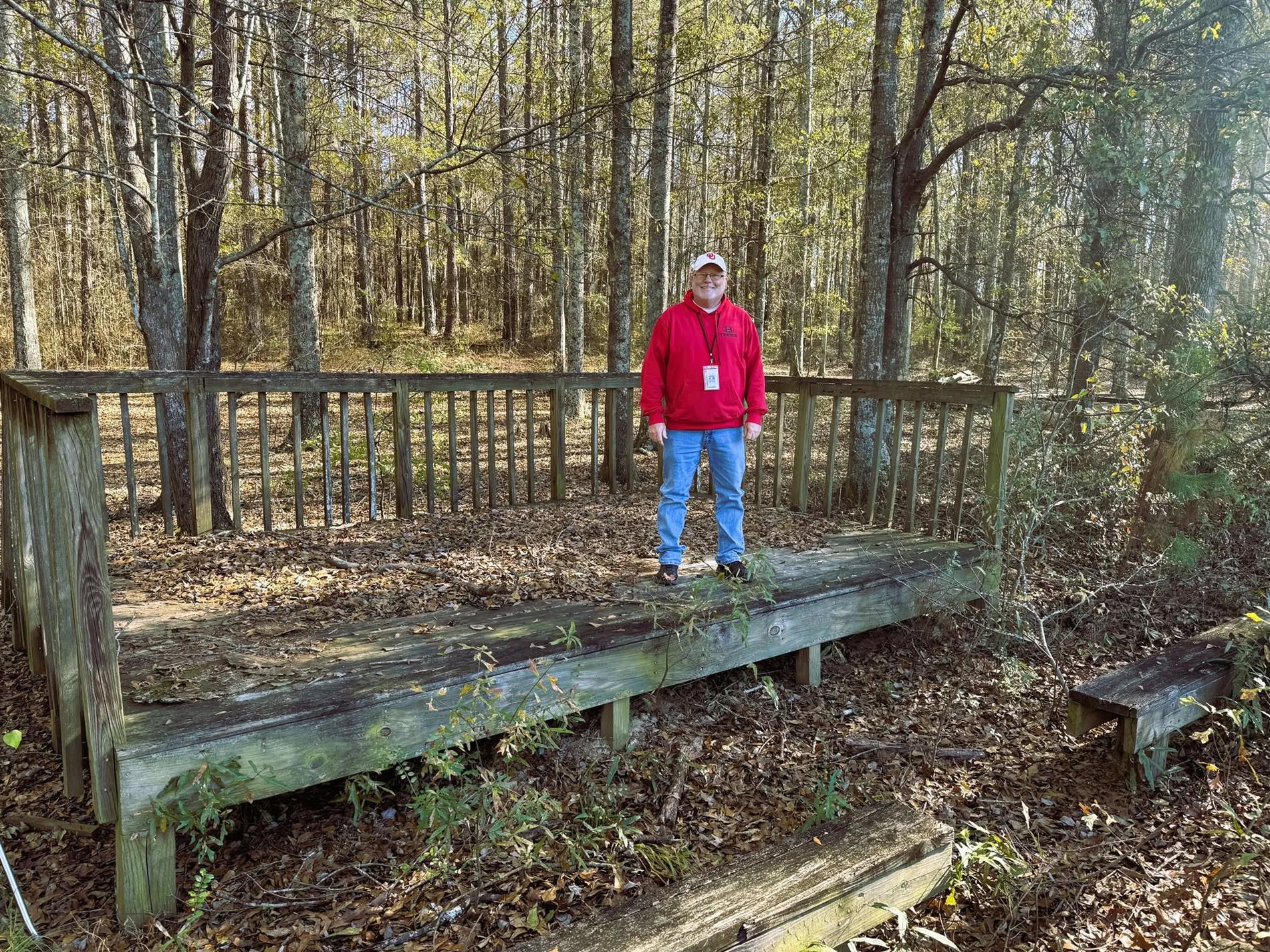 Mr. Phelps standing in the outdoor classroom before it was restored