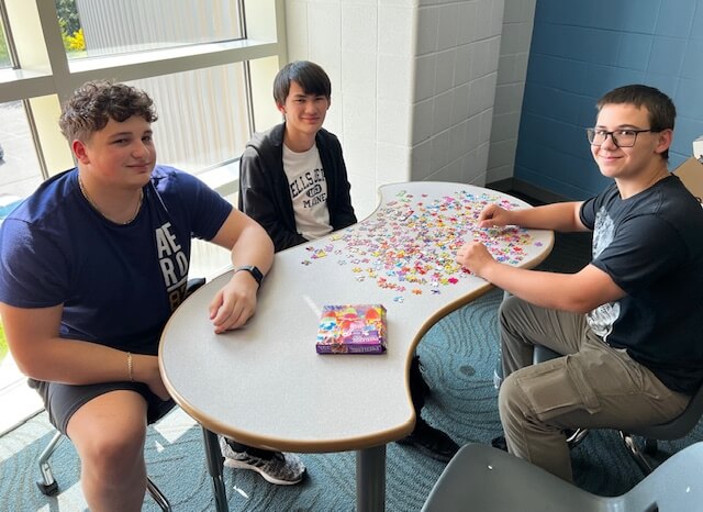 Photo of students working on a library puzzle