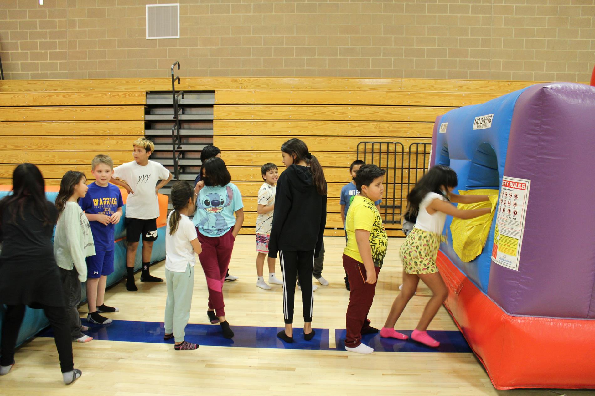 Students lining up for the inflatable obstacle course