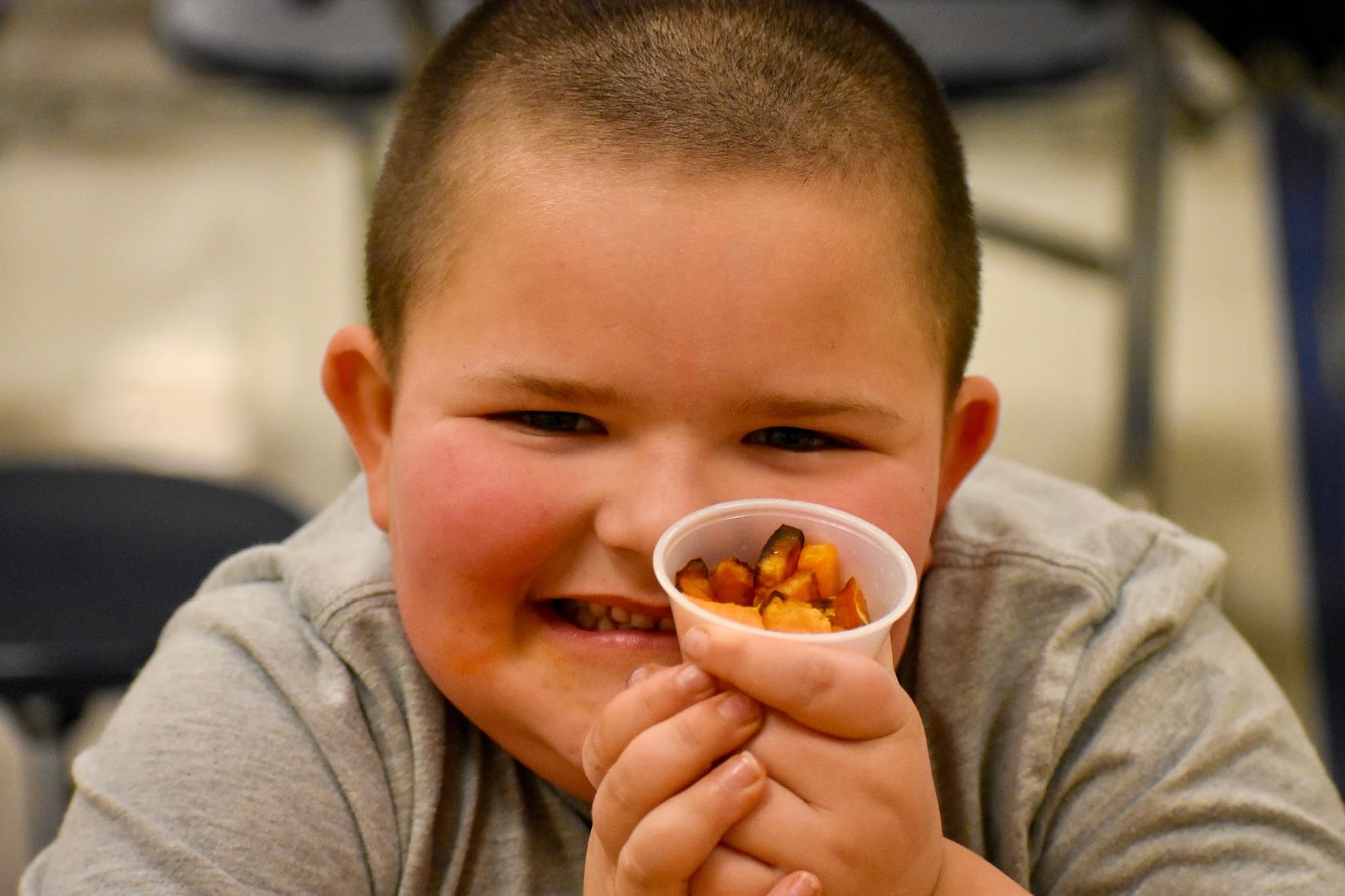 student with sweet potatoes