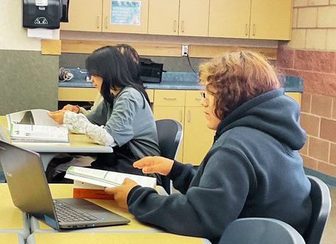 Middle school students reading at their desks