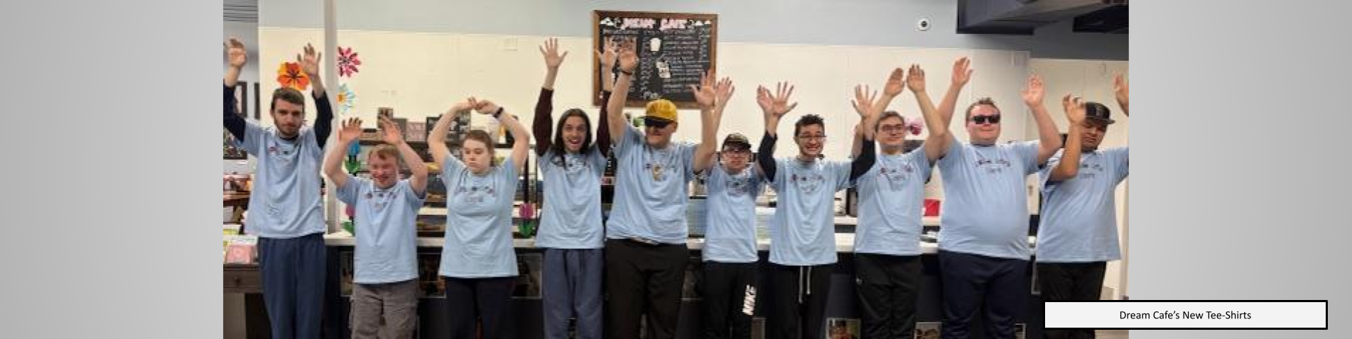 Dream Cafe student's posing for a group photo in their new tee shirts