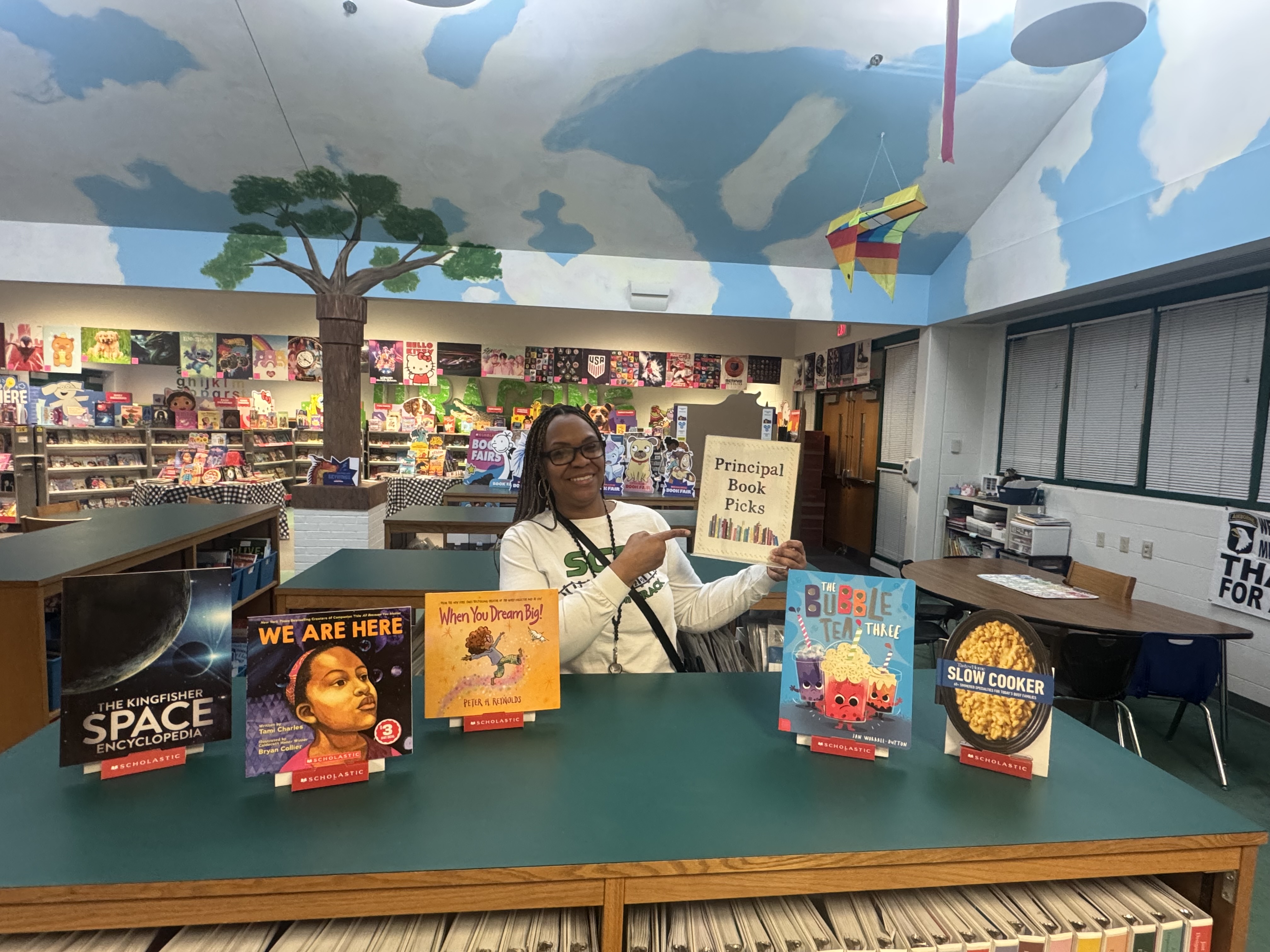 Mrs.Gray showing off her principal book picks!