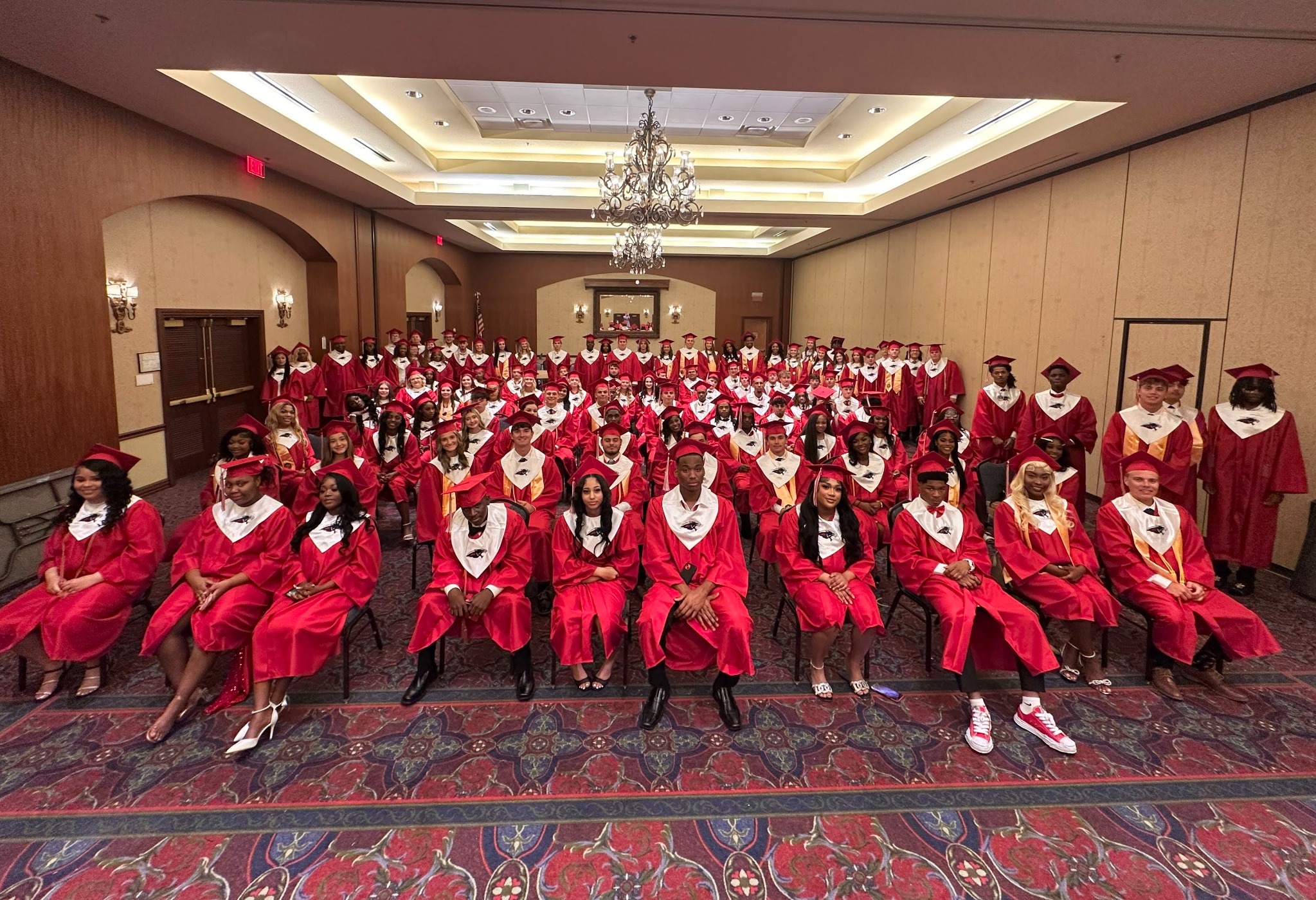 Bunkie High School graduates together in red caps and gowns
