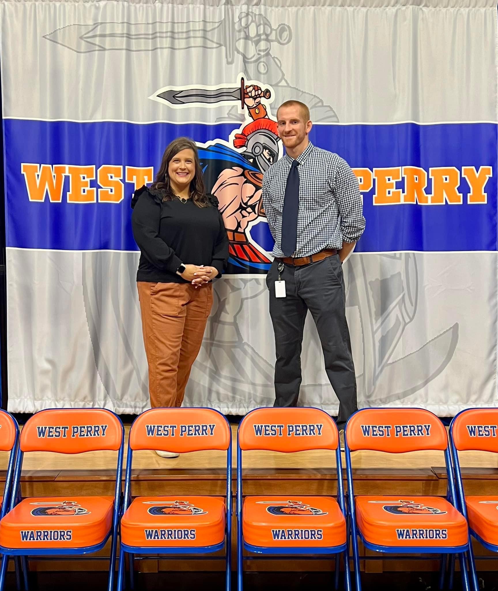 Principals standing in front of West Perry Sign