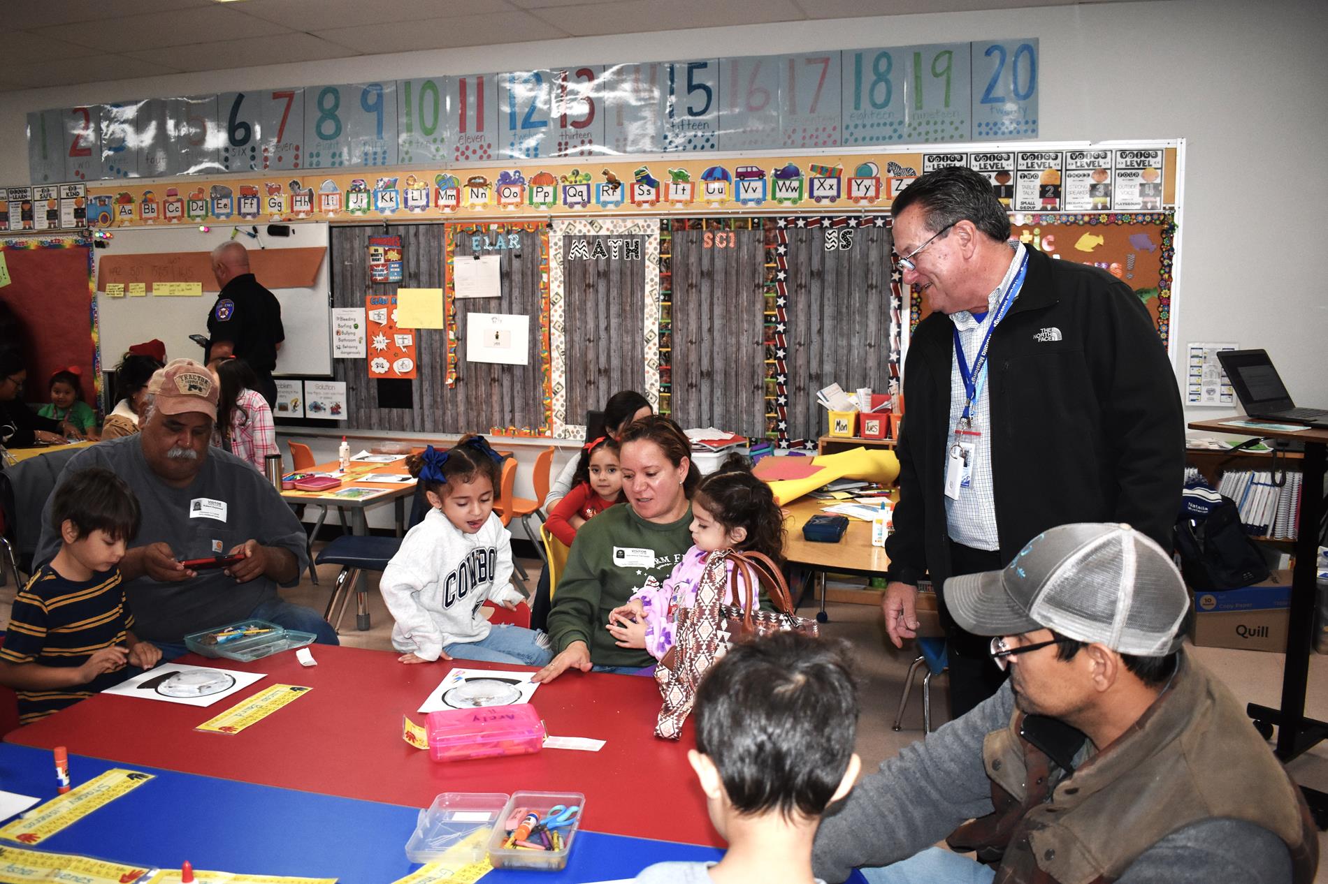 Parents and students working snow globe project