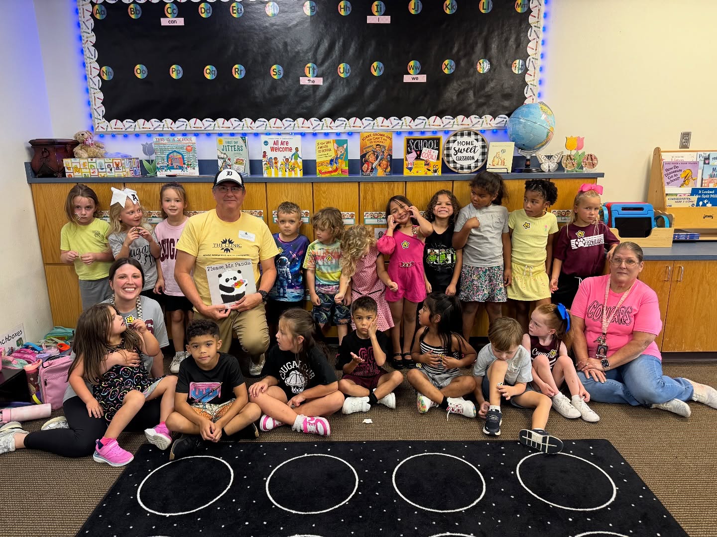 Mark Bratcher poses with kids at Ada Early Childhood Center.
