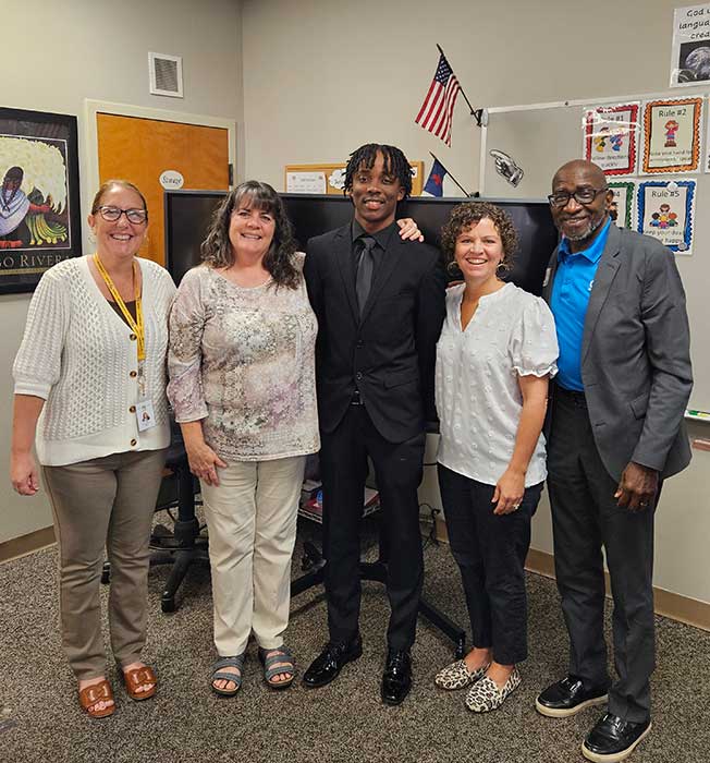 Staff and student posing