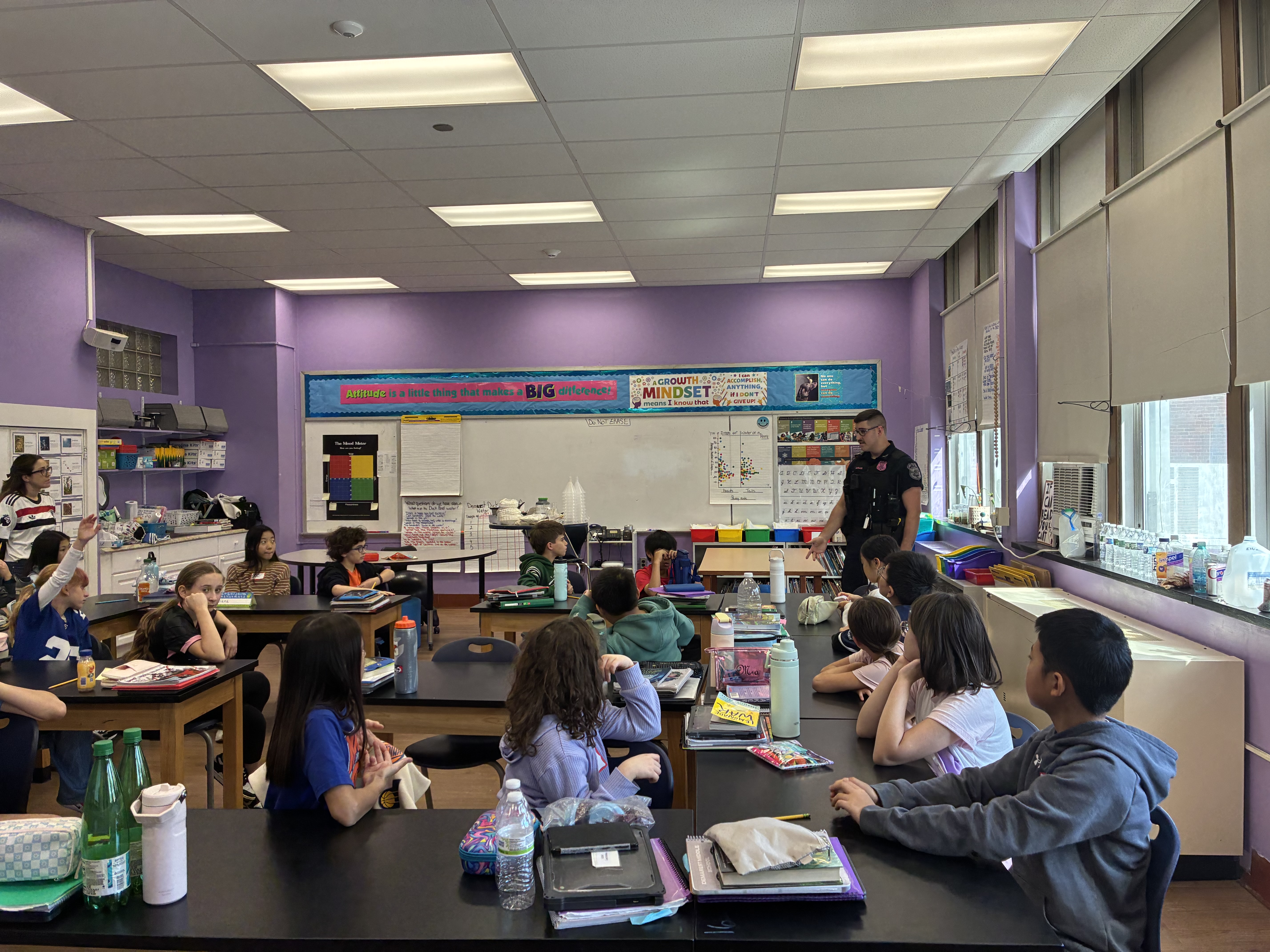 Police officer speaking with a group of students.