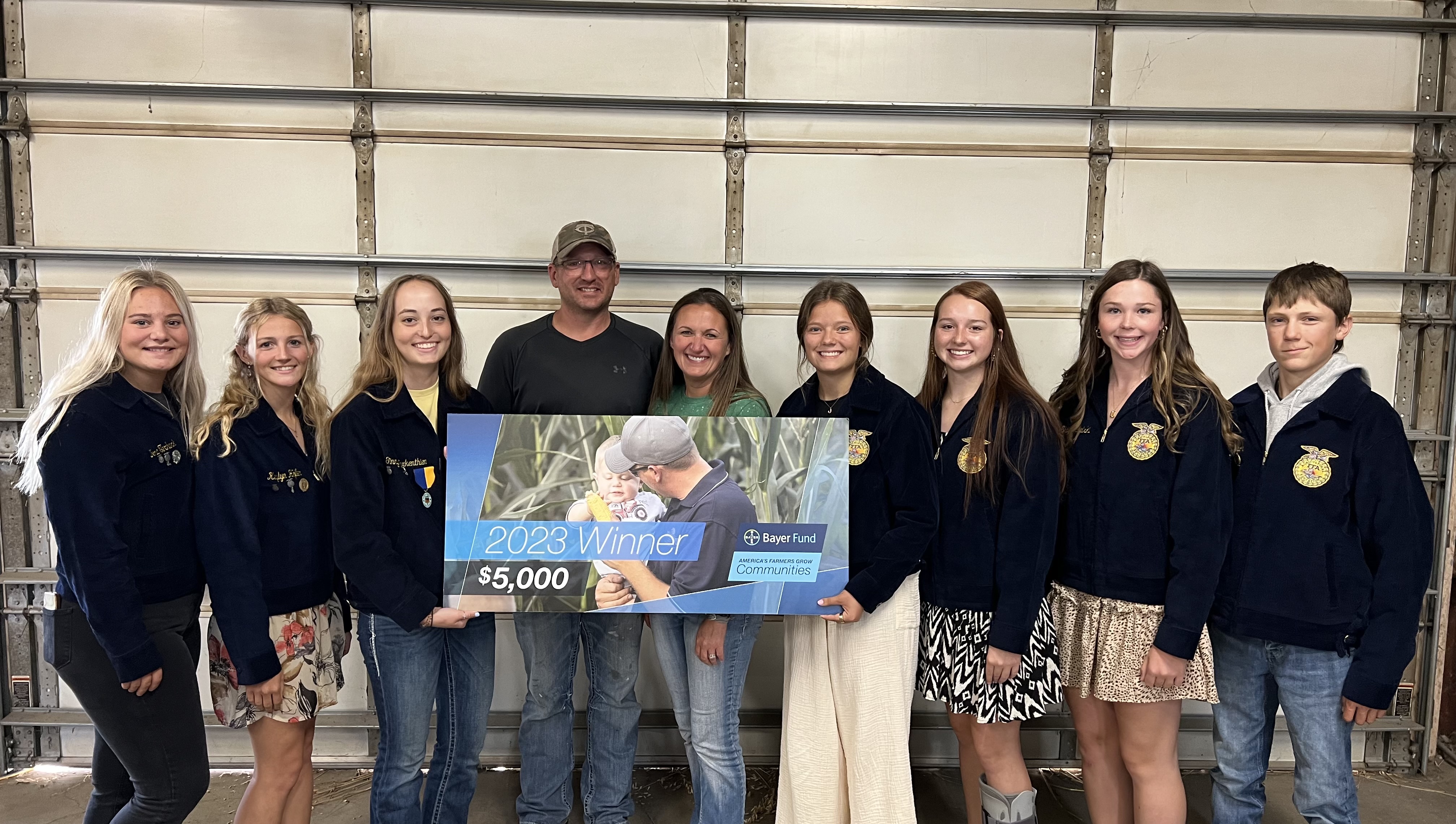 Pictured are the Willow Lake FFA officers receiving the Bayer Farmers Grow  Communities grant from Tony & Lucy Vandersnick.  From left to right, Nora Terhark, Kaylyn Hofer, Ginny Warkenthien, Tony Vandersnick, Lucy Vandersnick, Emma Peterson, Sami Brenden, Shay Michalski, and Andrew Peterson.
